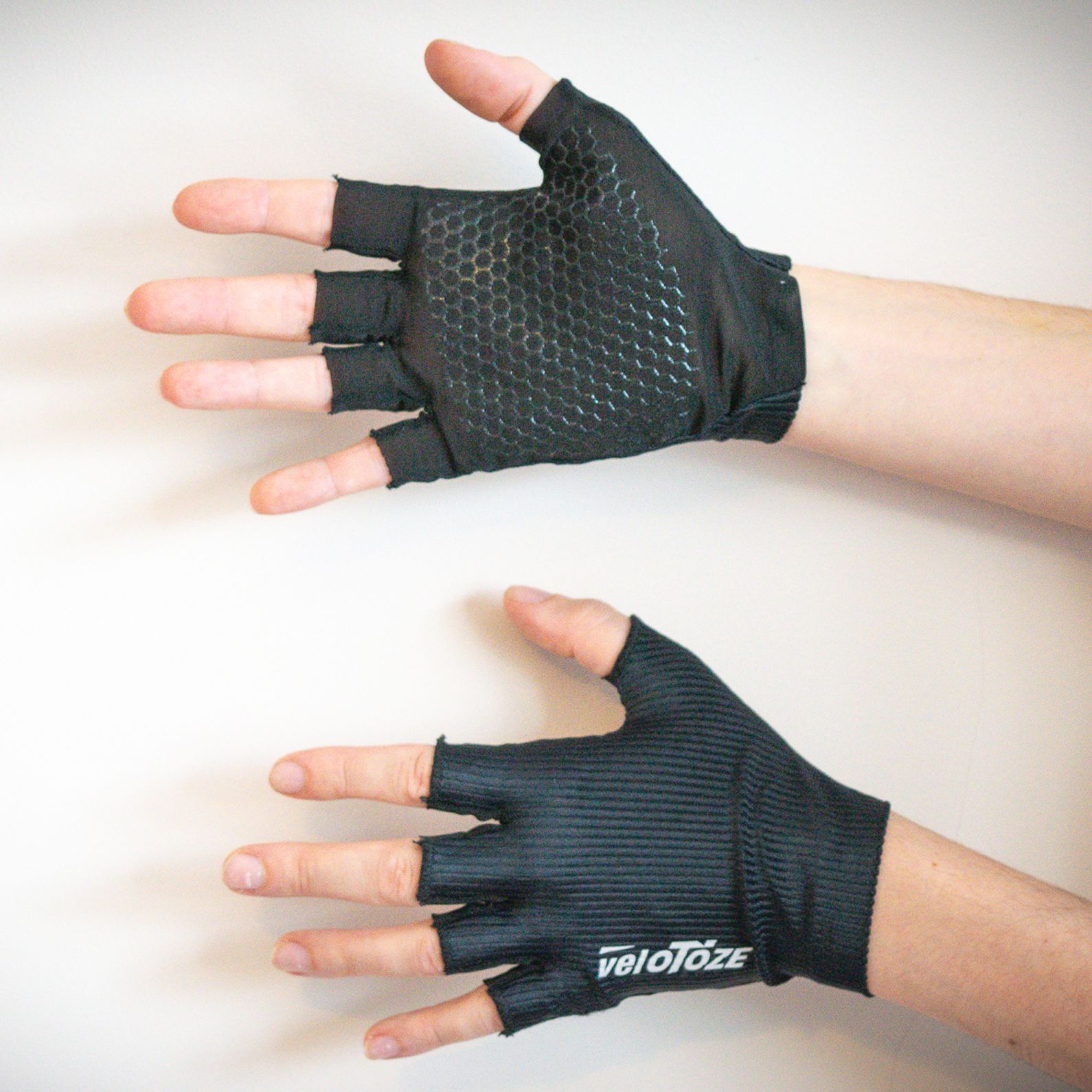 Velotoze Featherweight gloves being worn against a white background