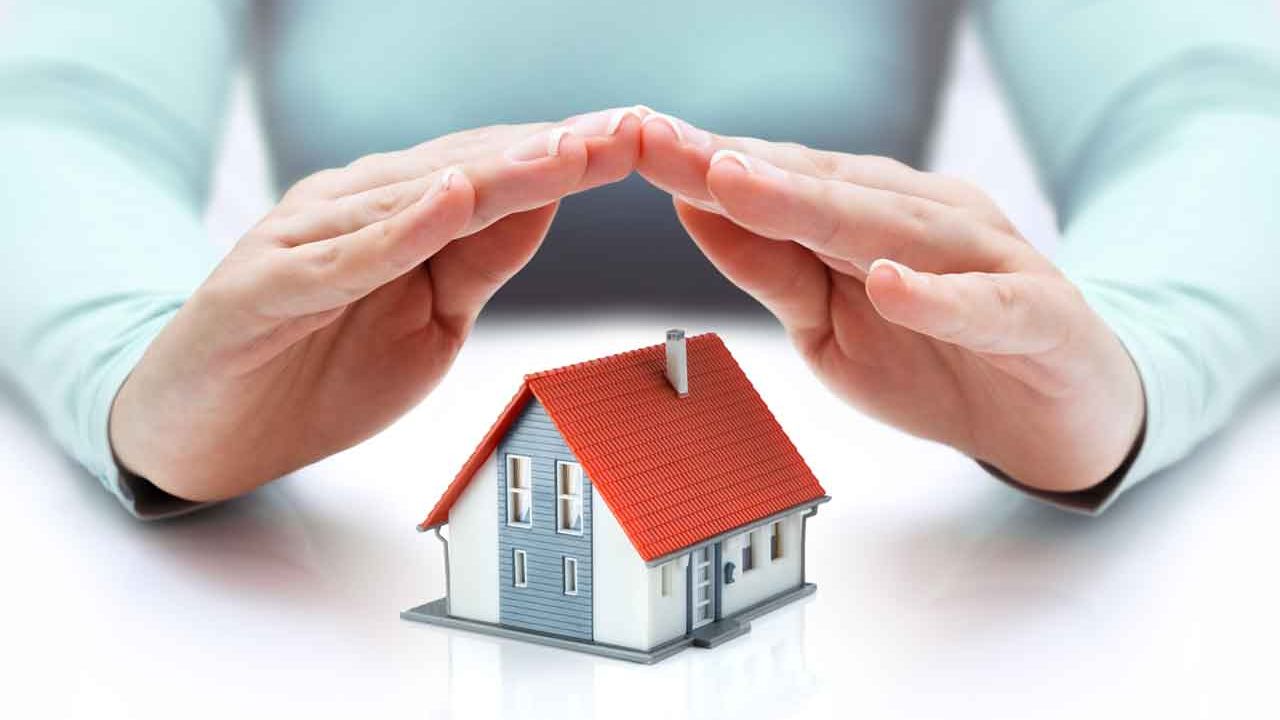 a hand folds over a model home