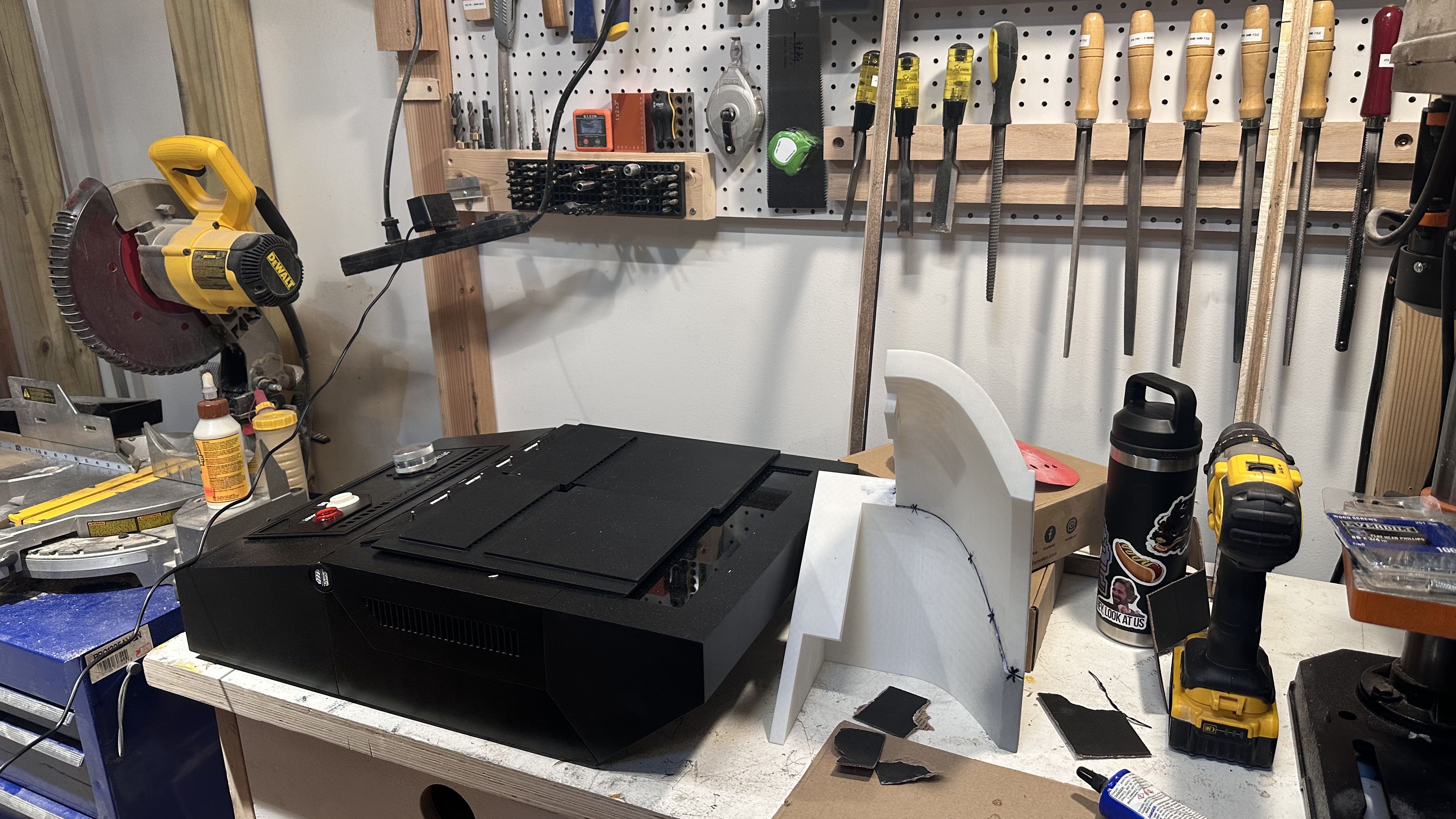 A photo shows a cluttered work station