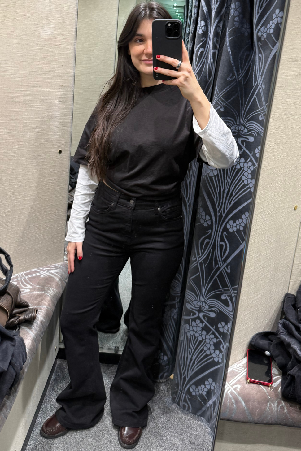 Sofia wearing flared black jeans