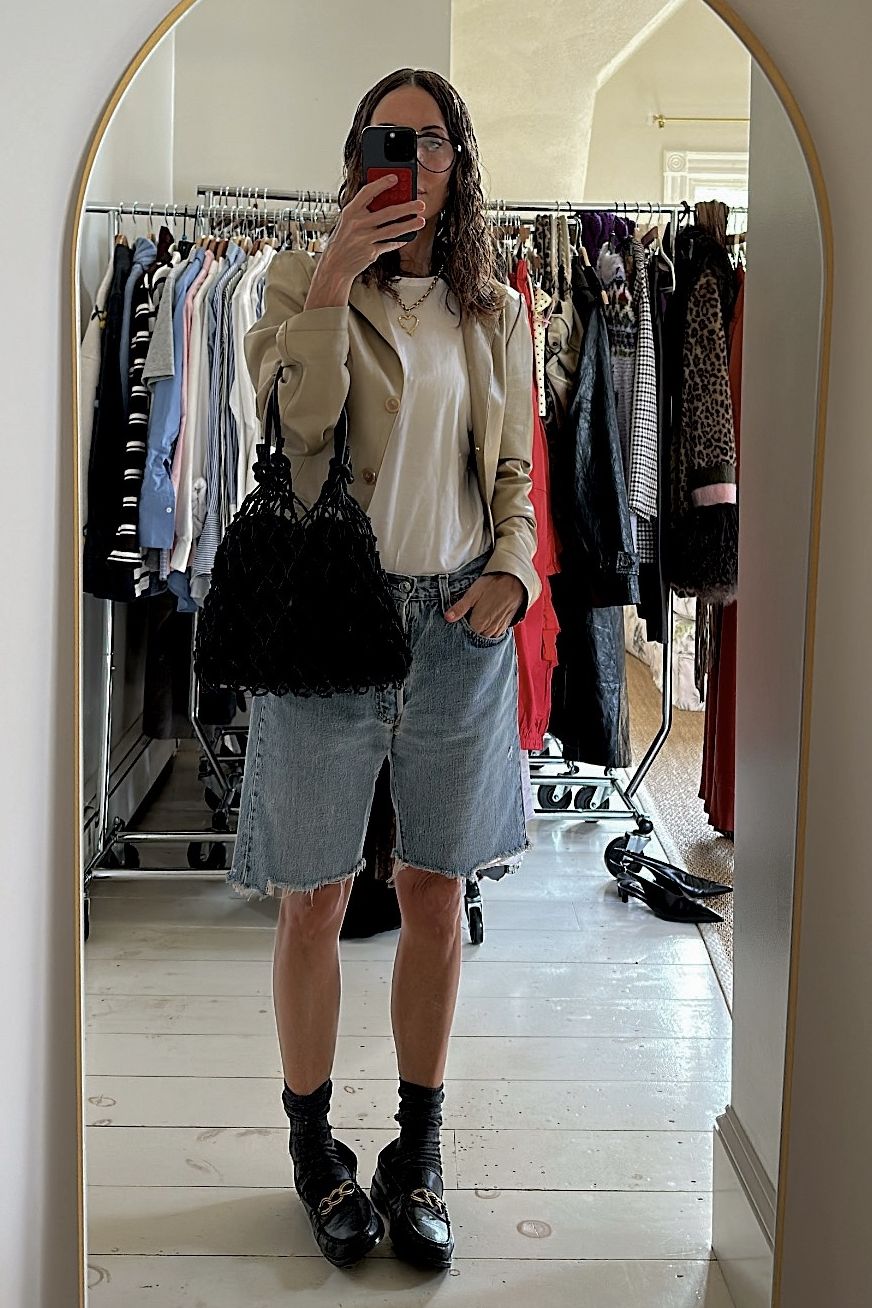 Larissa Mills wearing denim shorts and loafers
