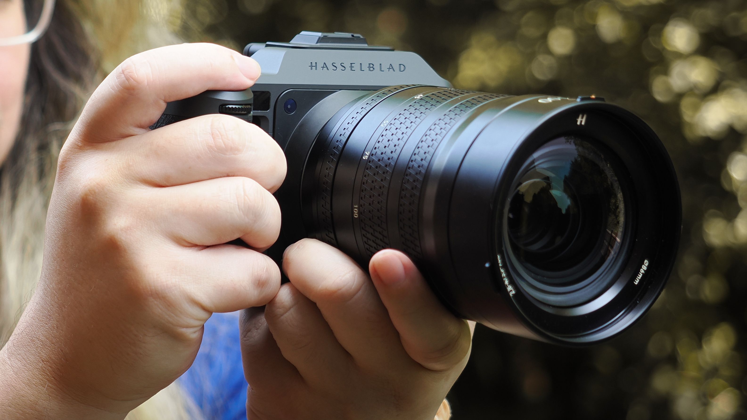 Photographer James Artaius holding a Hasselblad X2D II 100C with Hasselblad XCD 35-100E
