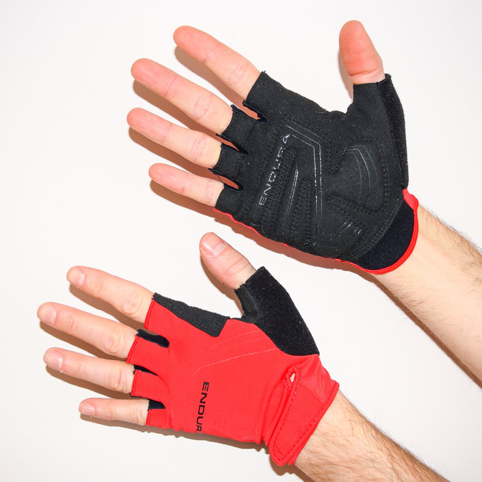 Endura XTRACT cycling gloves being worn against a white background