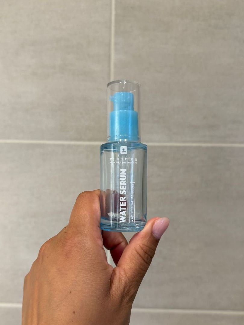 Aleesha holding empty Erborian Water Serum