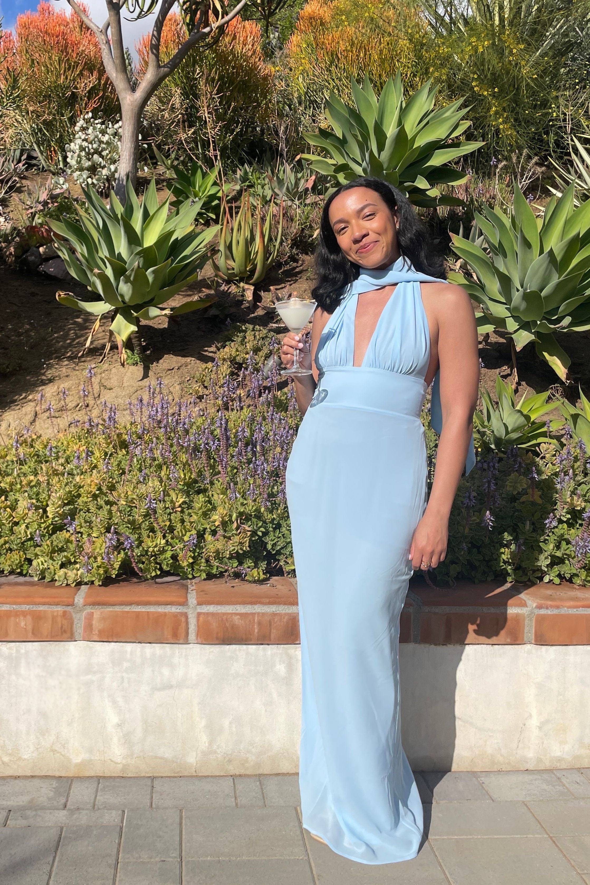 Lauren Tappan wearing a blue wedding guest dress from Meshki