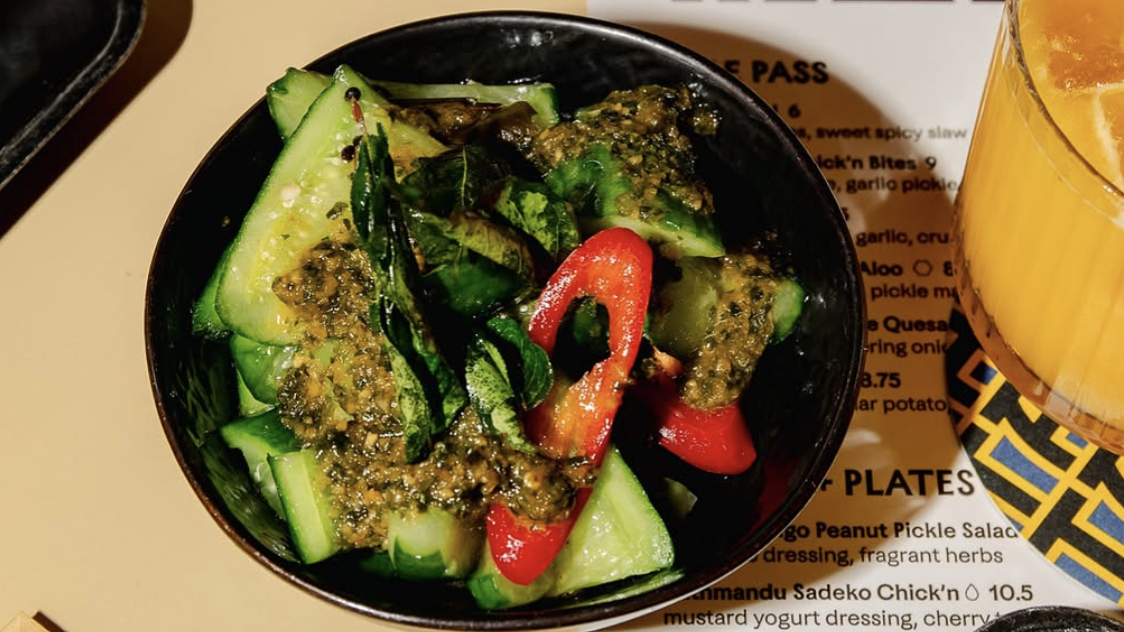 an image of a cucumber starter dish on a table of food at Tangra