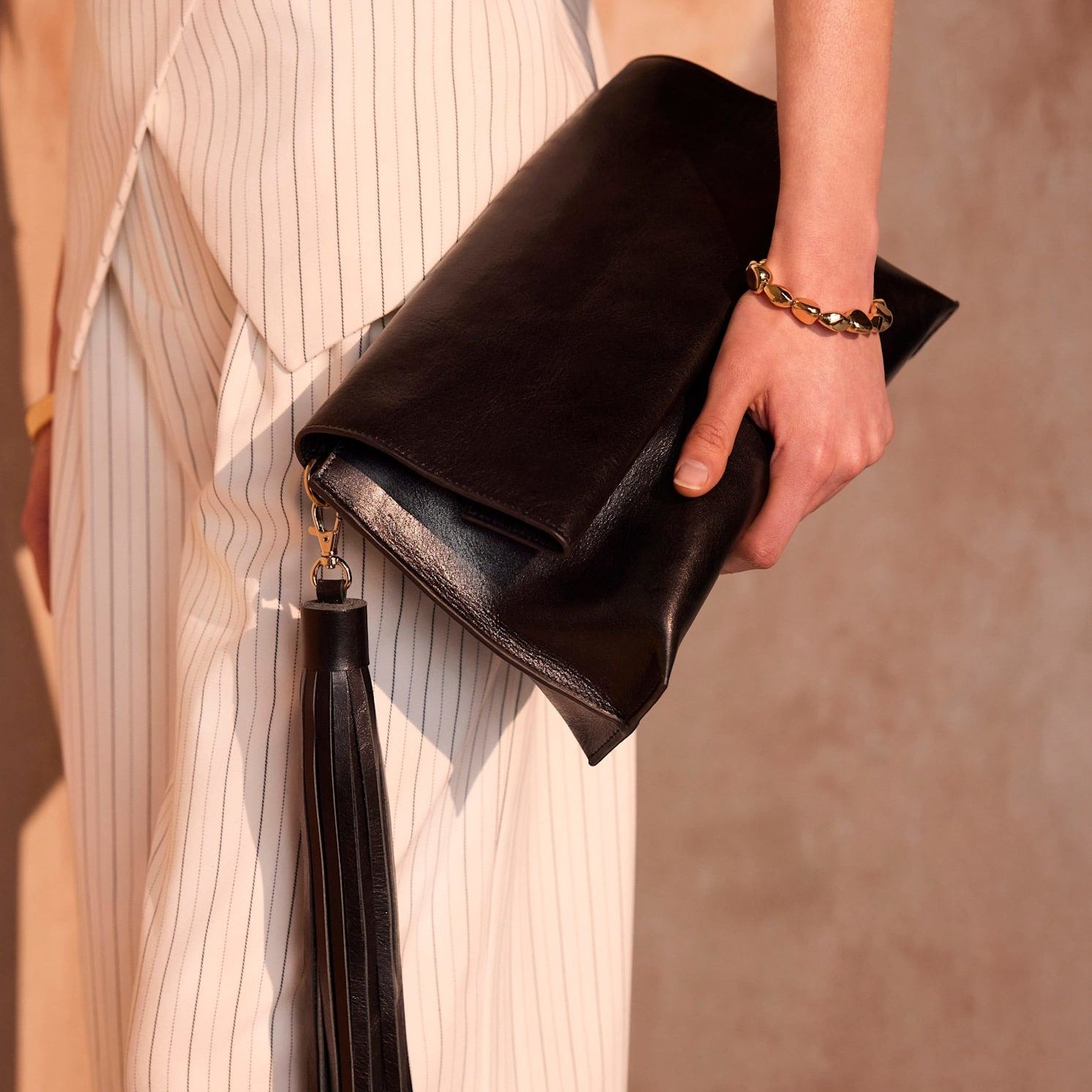 Daisy Black Leather Fold Over Tassel Clutch