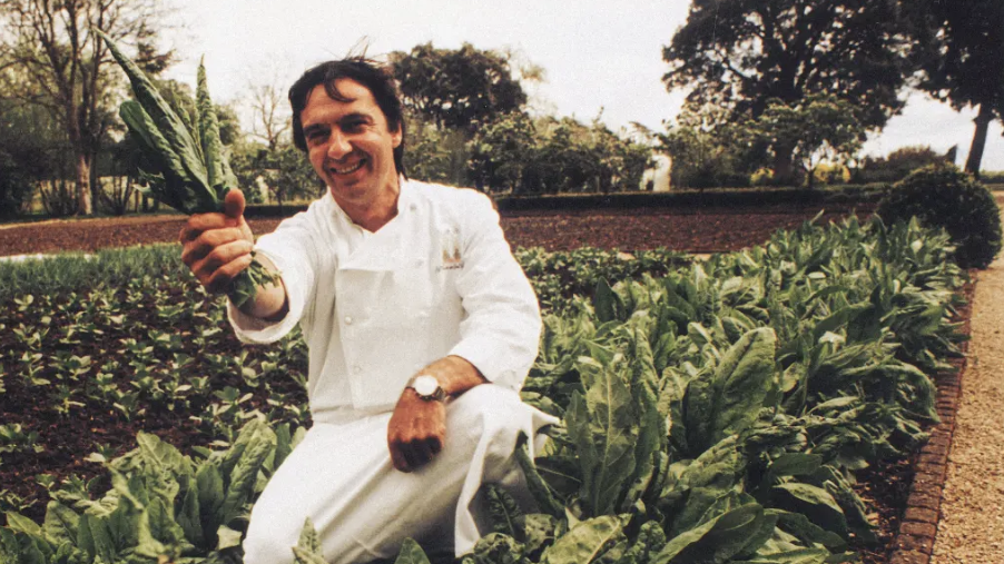 an old image of Raymond Blanc in a field picking Cavelo Nero