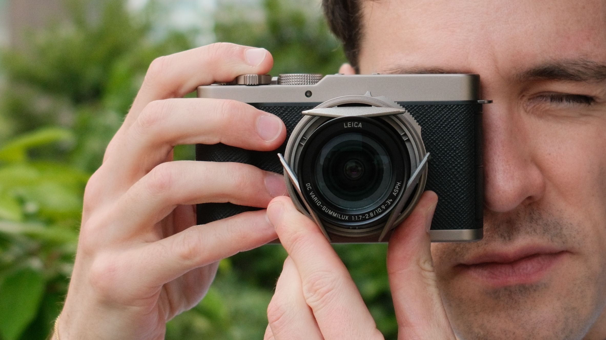Rear view of the Panasonic Lumix L10 compact camera held in one hand.