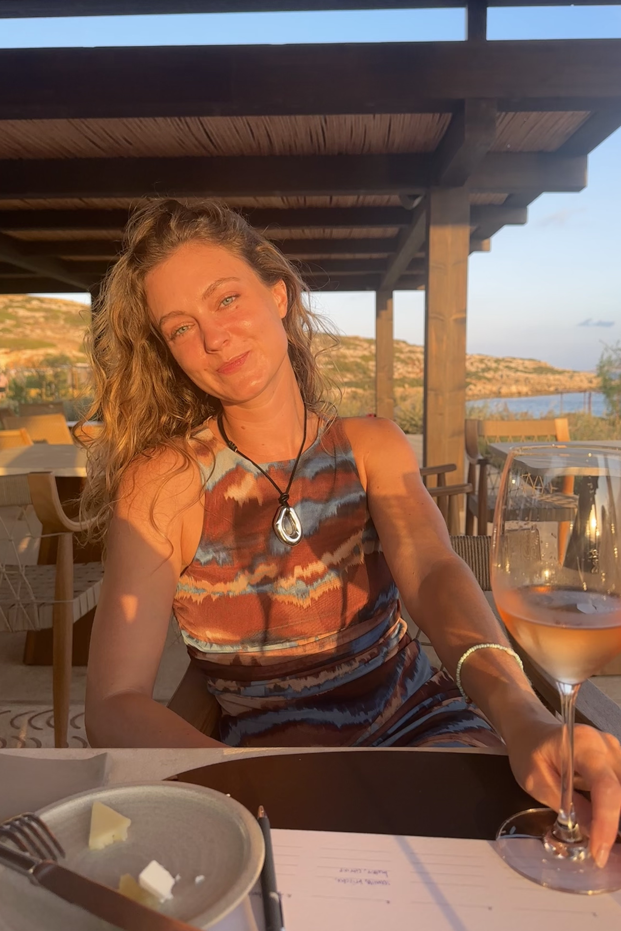 woman in the sun with a glass of wine