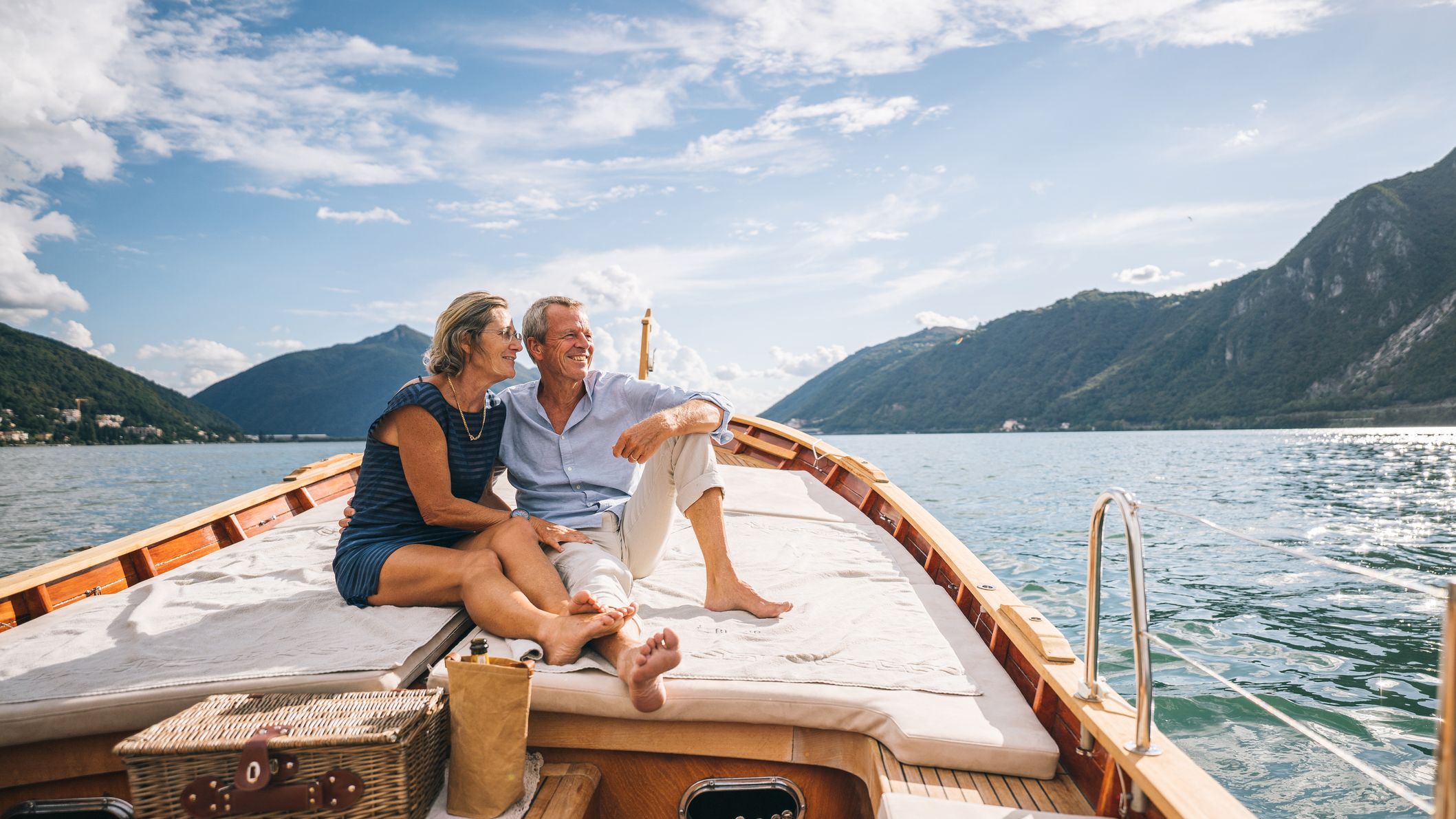A senior couple enjoys time together on a boat, Lake Lugano, Italy.