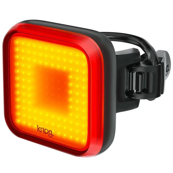 A red bike light on a white background
