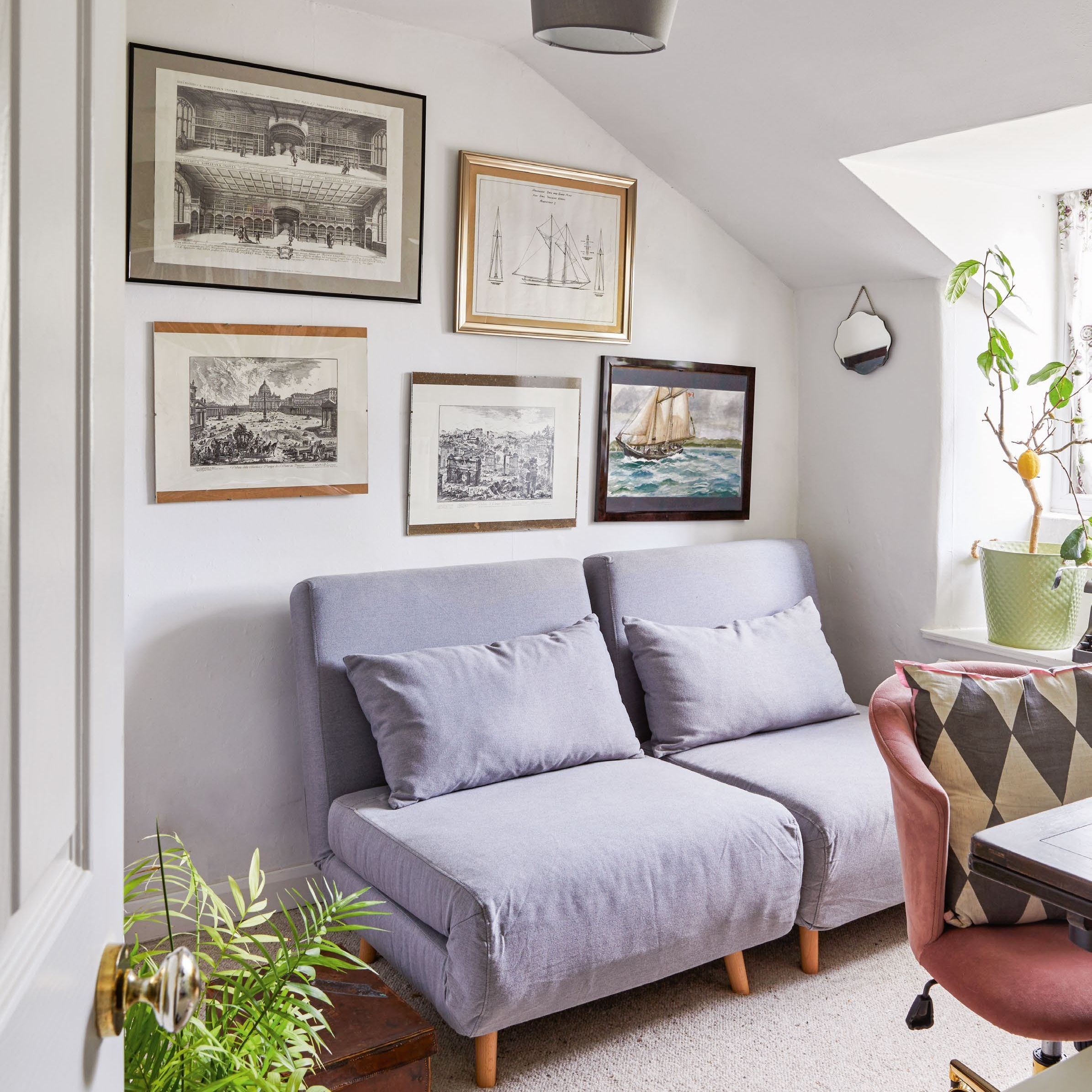 Small attic room used as home office and guest bedroom with pull out beds