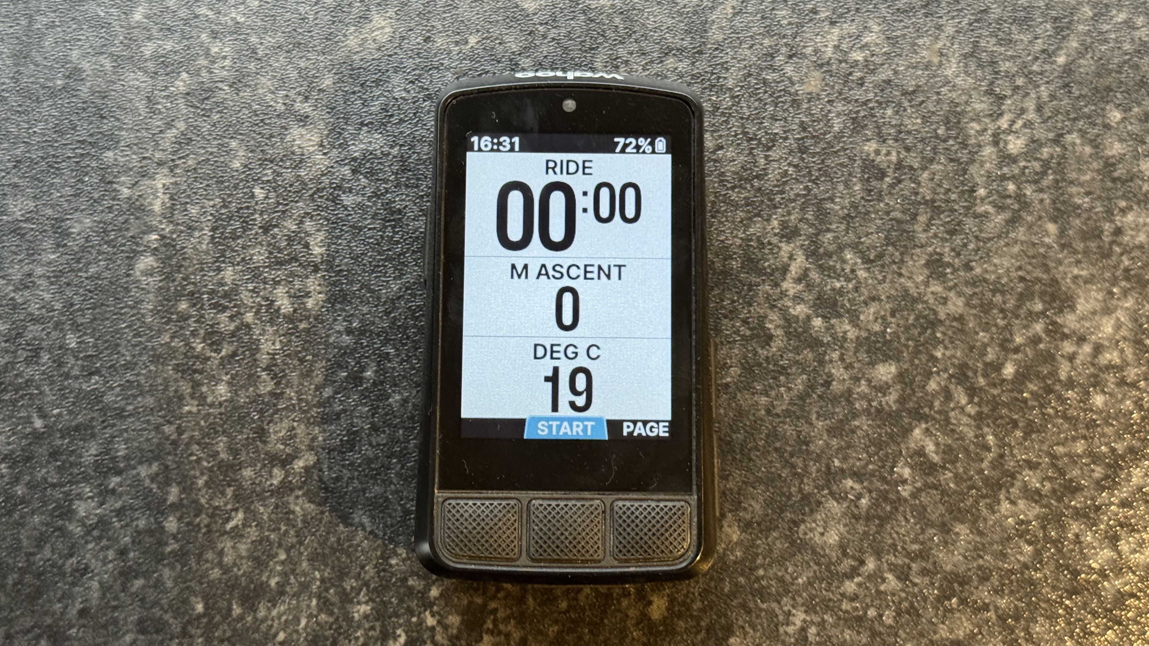 Wahoo Elemnt Bolt 3 sat on a kitchen worktop, in ride mode and showing ride time, ascent in metres and the temperature in degrees.