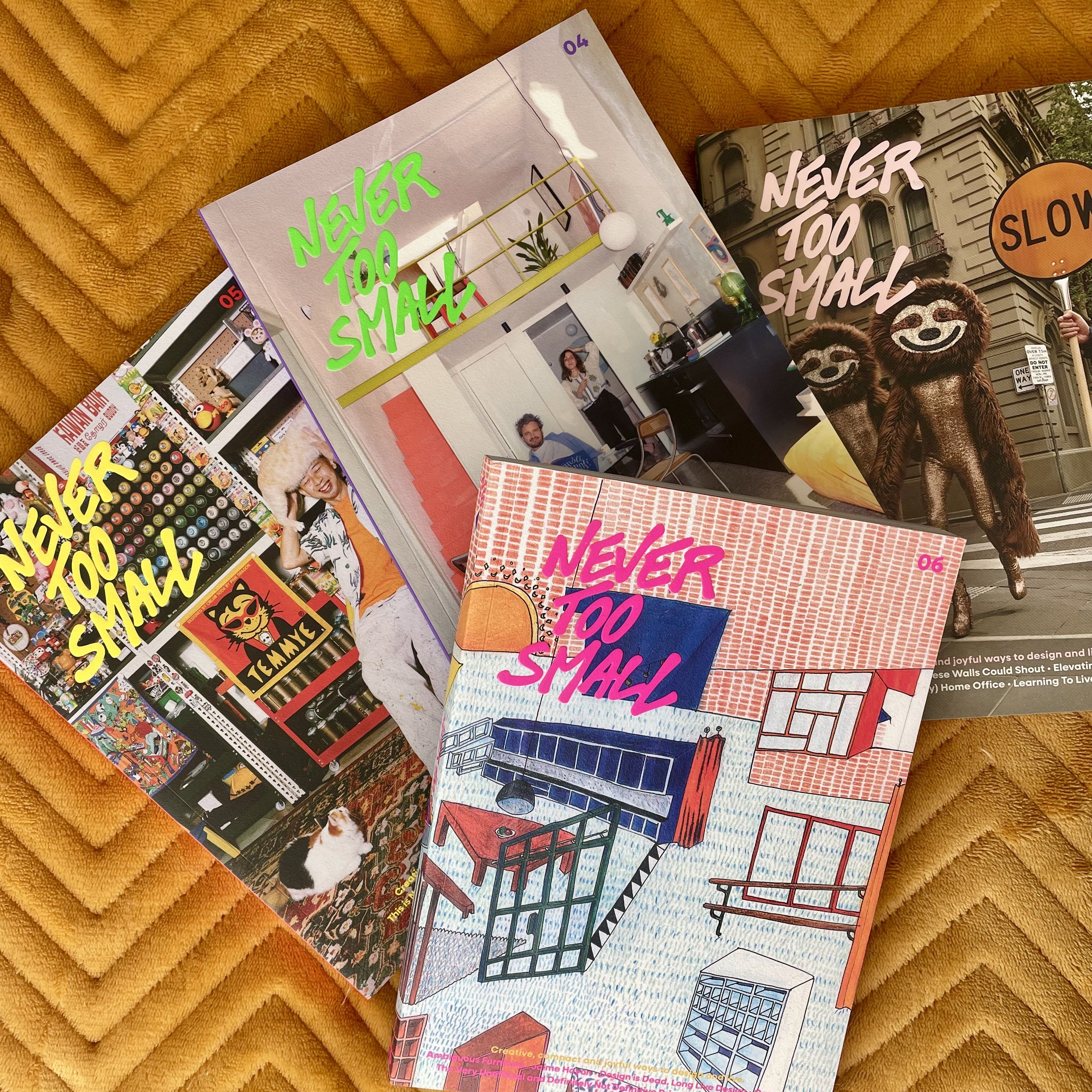 Pile of Never Too Small magazines sitting on mustard-yellow fabric
