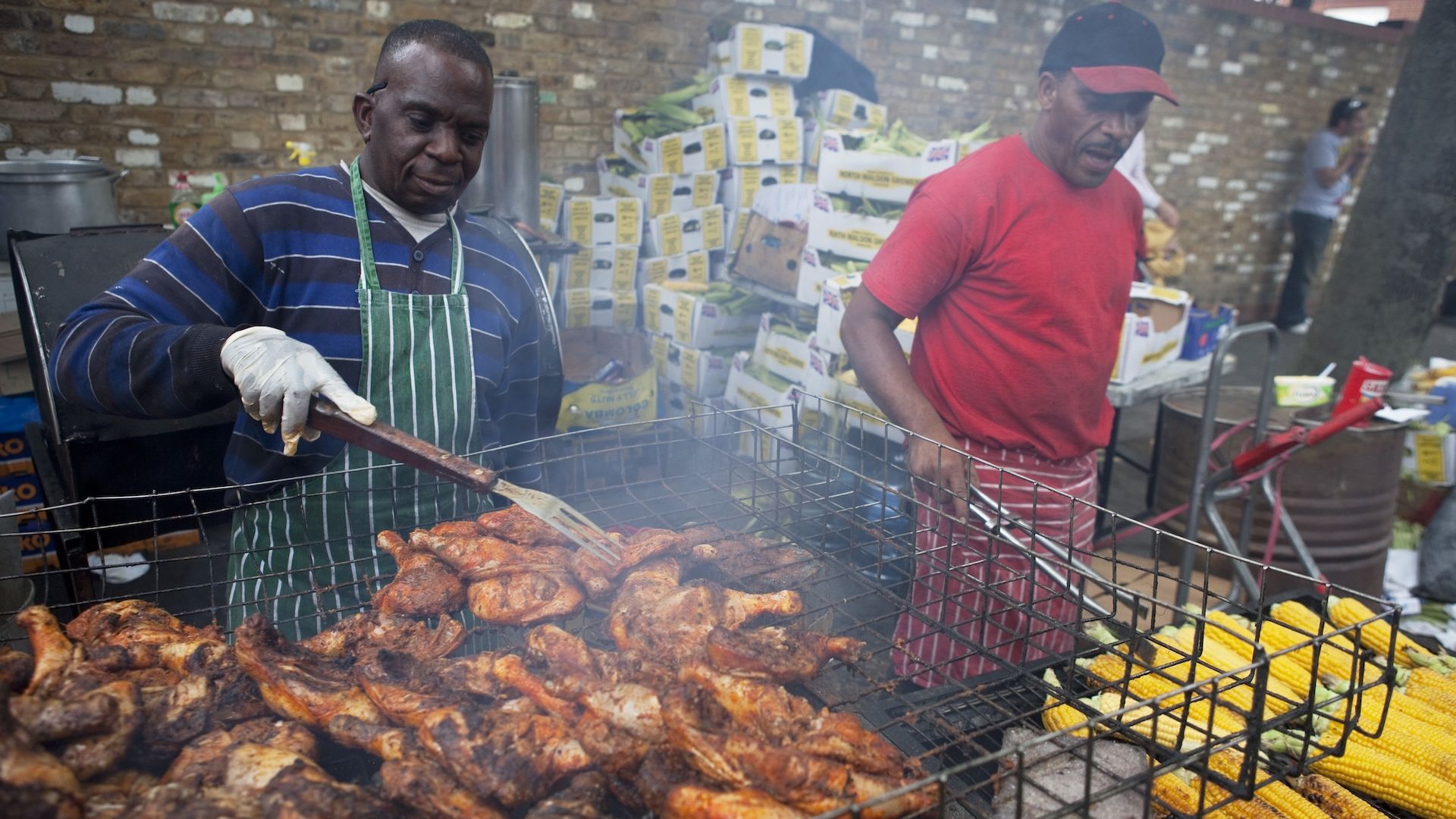 Caribbean style jerk chicken and corn is barbecued at one of the many food stalls at the Notting Hill Carnival.