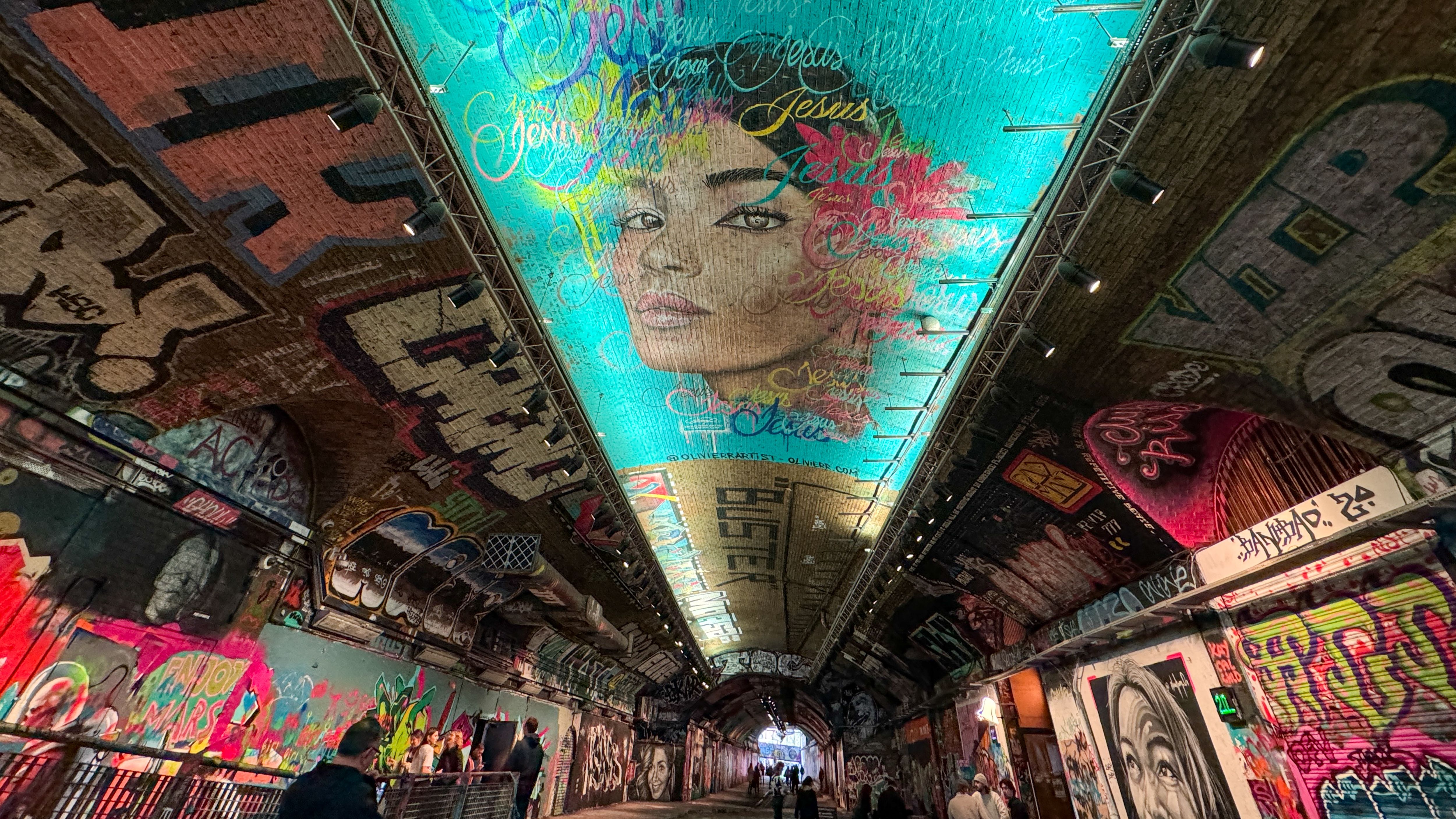 LONDON, ENGLAND - OCTOBER 23: People pass graffiti art sprayed on the walls of Leake Street Arches which is under the platforms and tracks of Waterloo station, on October 23, 2023 in London, England. With an array of notable tourist attractions, London, the capital city of England, is one of the world&amp;amp;apos;s most visited cities attracting millions of visitors every year. (Photo by Matt Cardy/Getty Images)