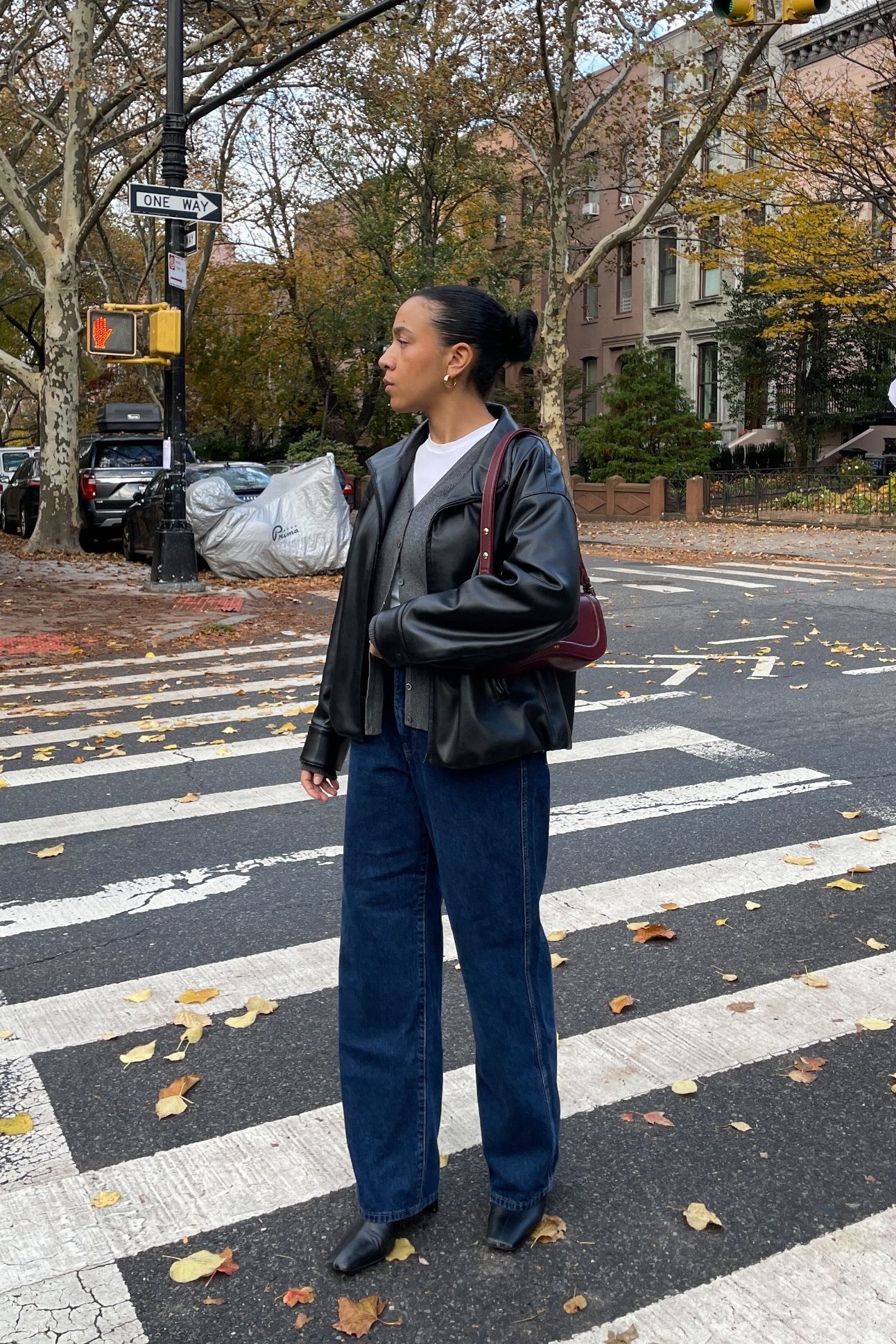 Lauren Tappan wearing a leather jacket, a sweater, and jeans