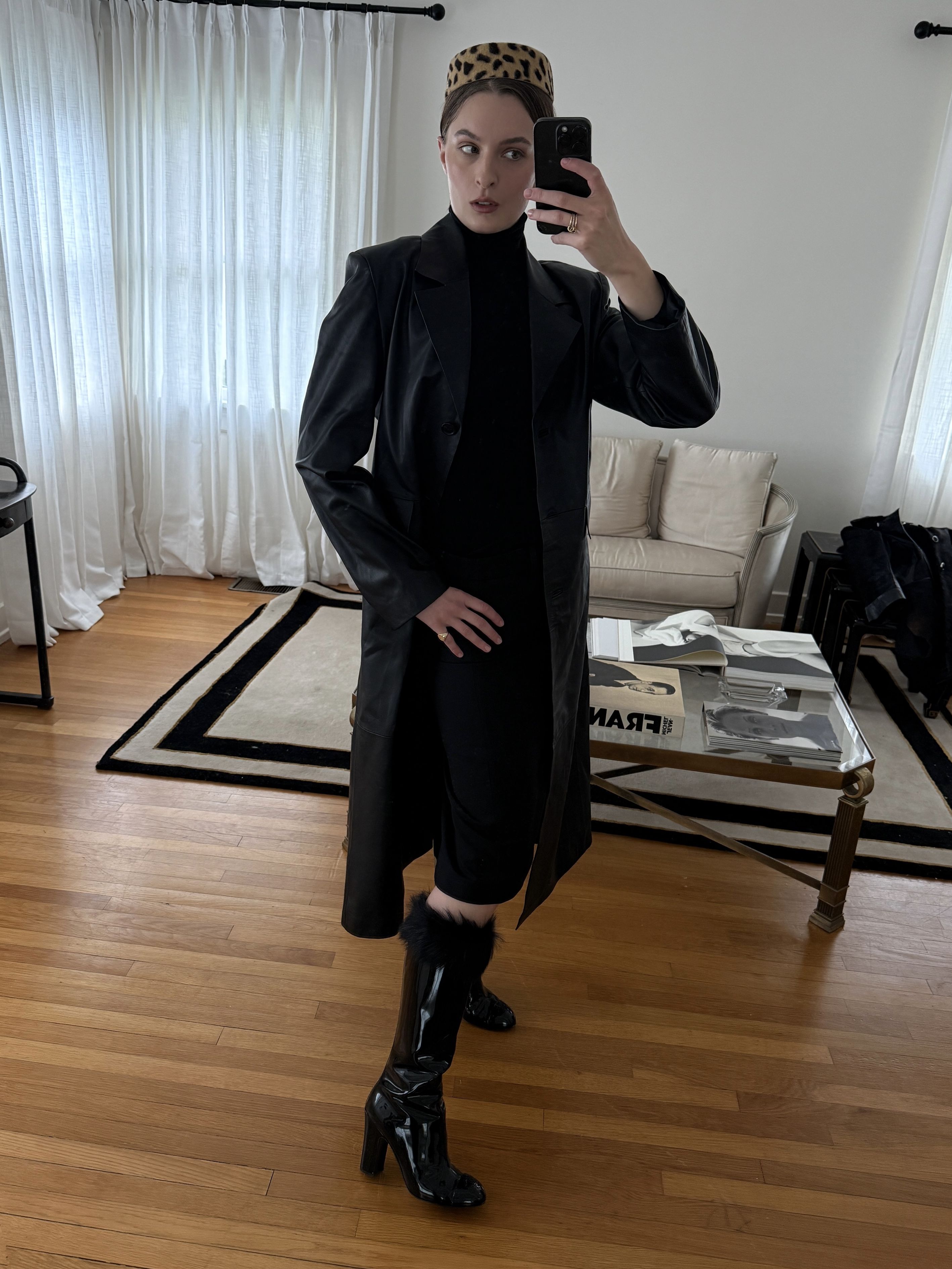 Christie Tyler wearing a black coat over a black dress and black boots