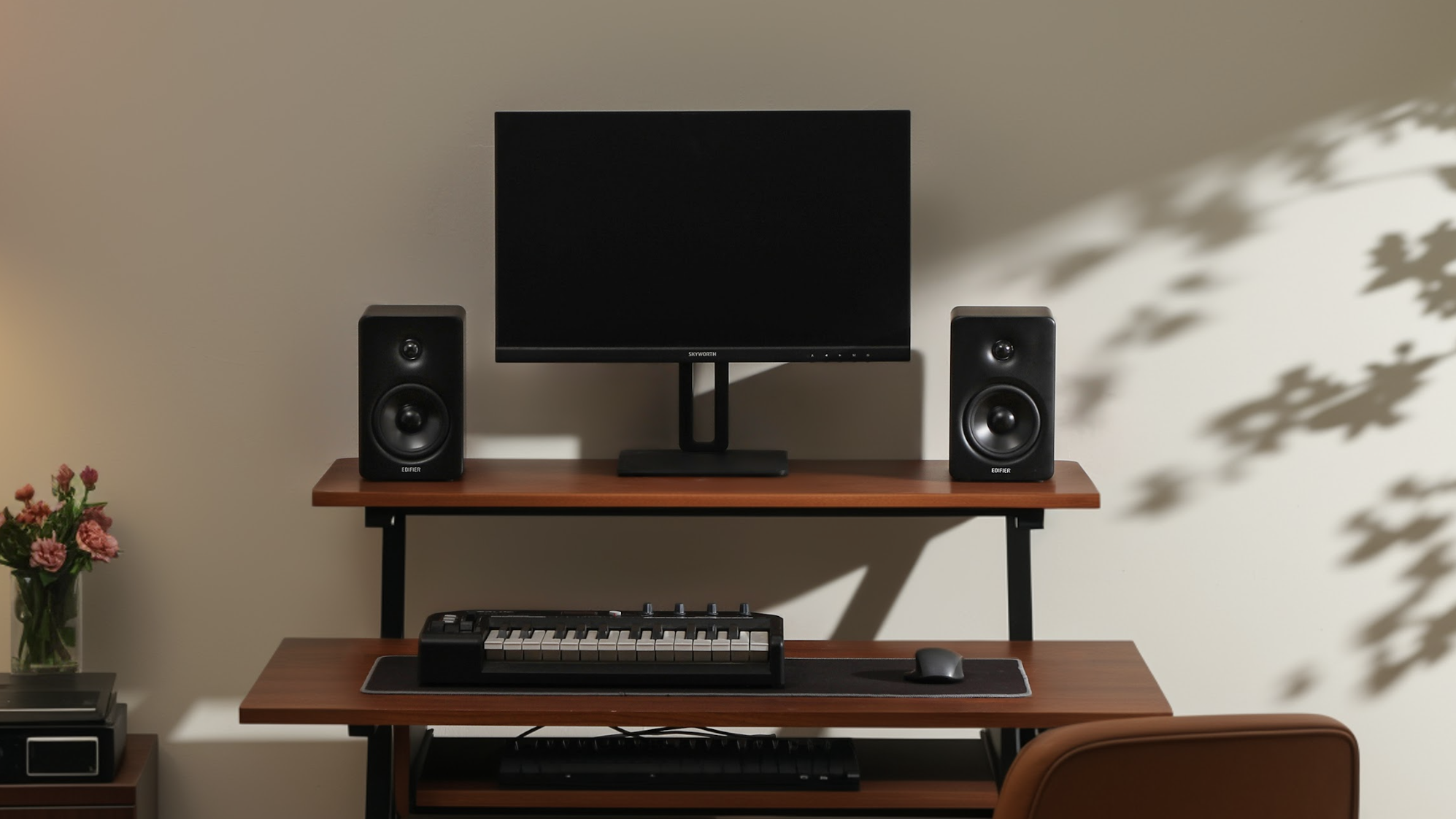 Edifier M90 speakers either side of a monitor in an office