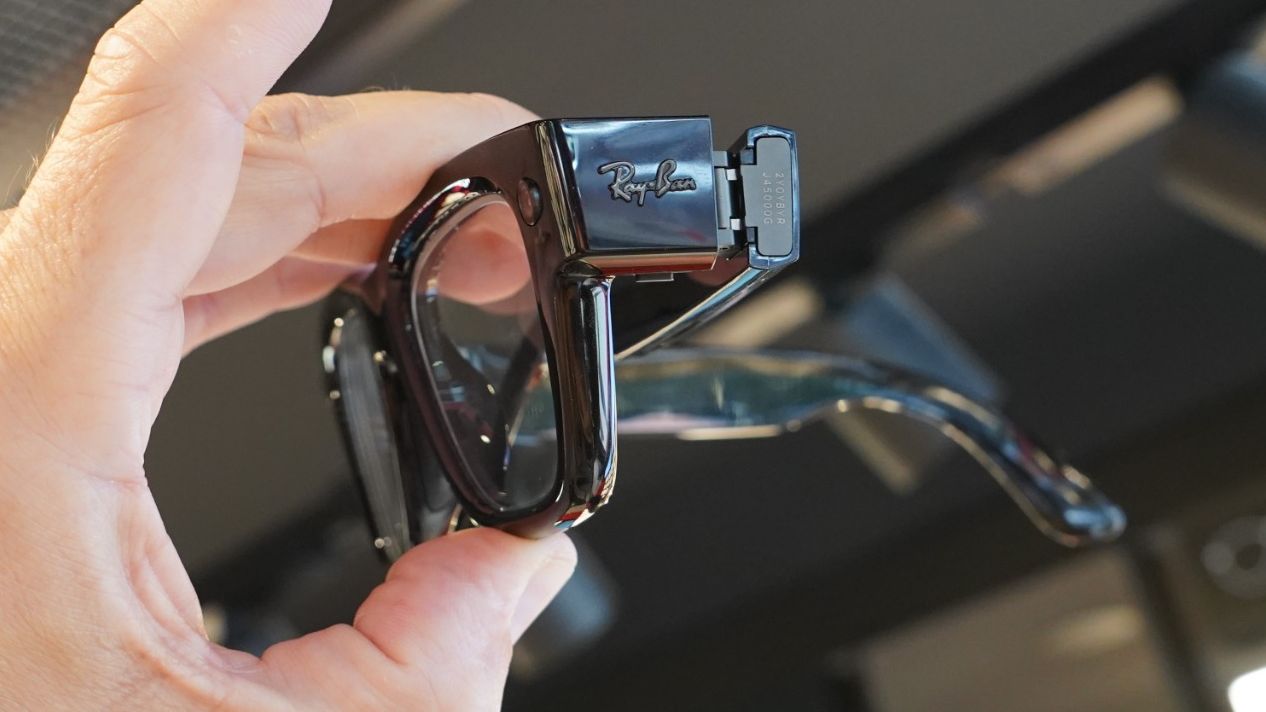 Meta Ray-Ban Display glasses seen from the side, held in the hand