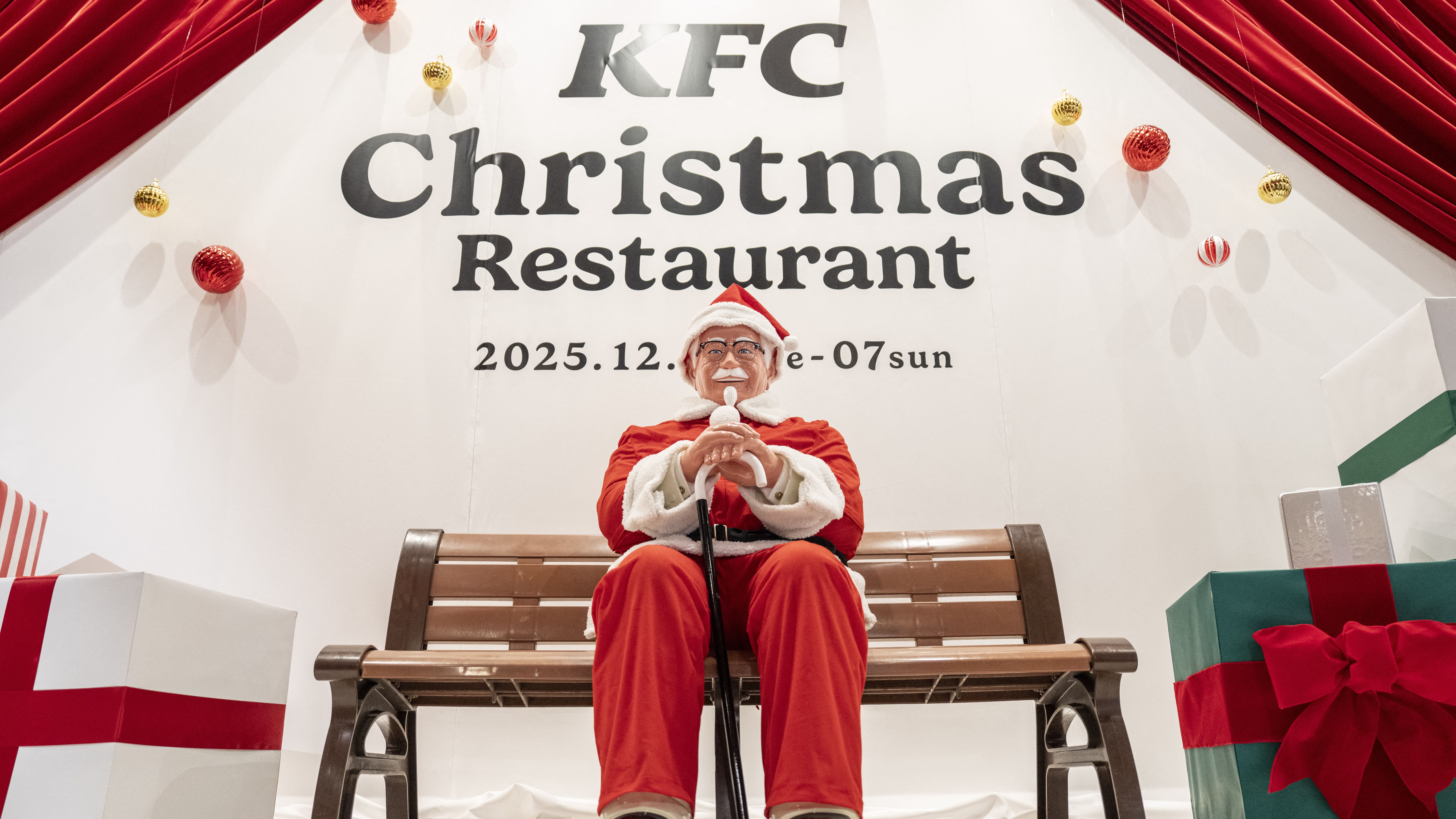 A statue of Colonel Sanders dressed as Santa Claus is displayed at the KFC Christmas restaurant in Tokyo on December 2, 2025. (Photo by Yuichi YAMAZAKI / AFP)