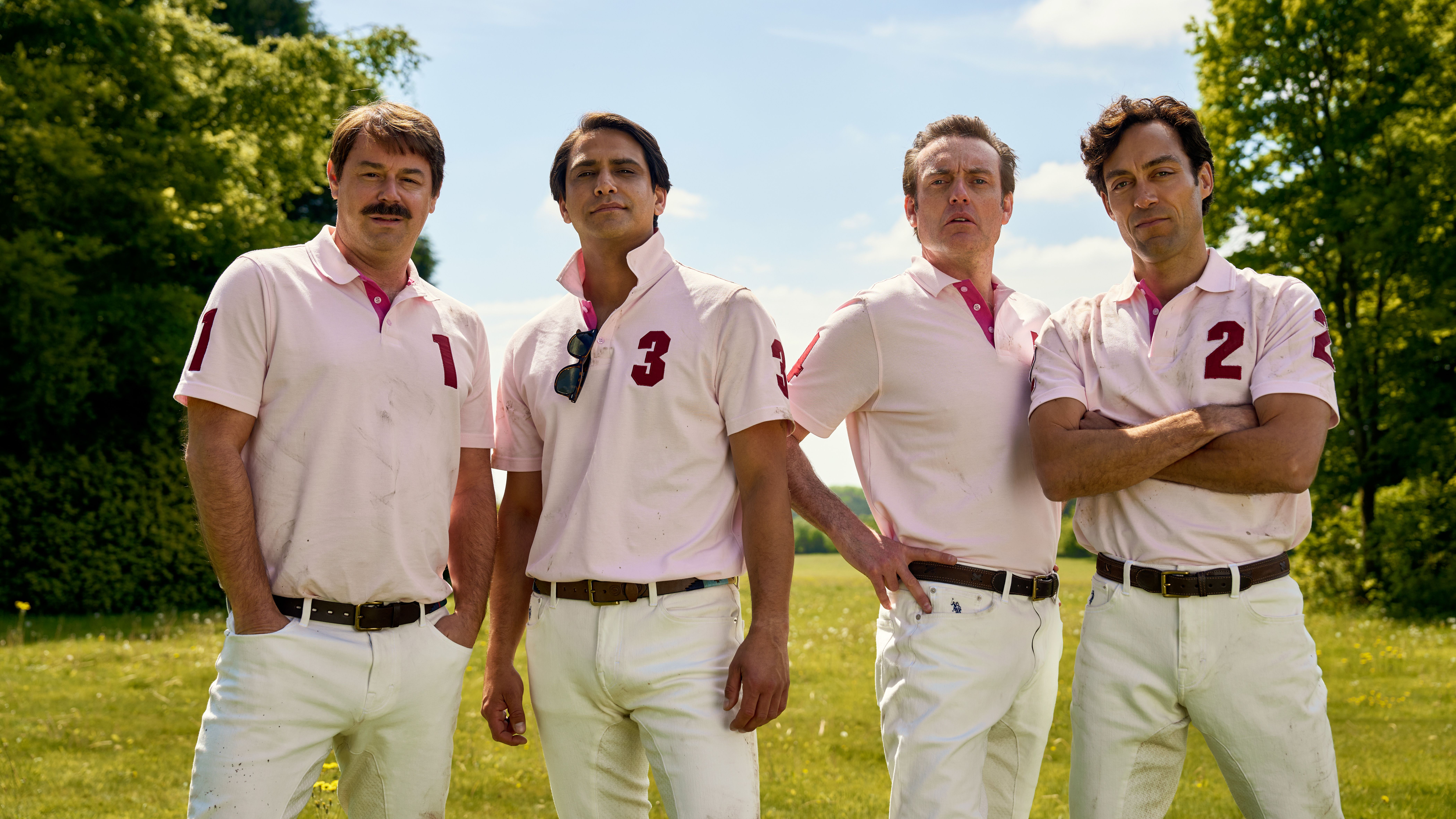 an image from Rivals, showing (from L-R): Danny Dyer, Luca Pasqualino, Brenden Patricks, and Alex Hassell all in Polo uniform