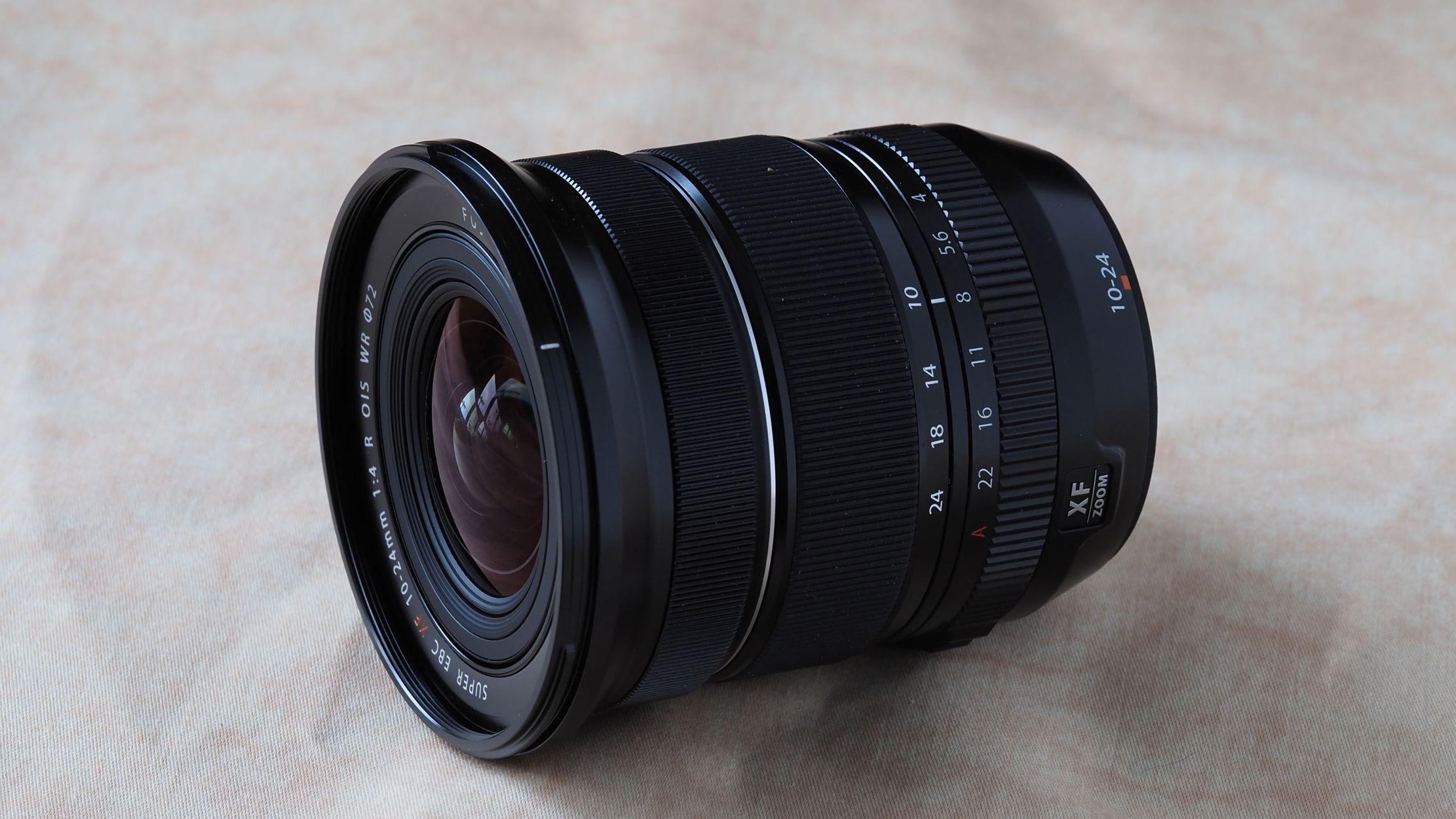 Fujinon XF 10-24mm f/4 R OIS WR camera lens on a marbled surface