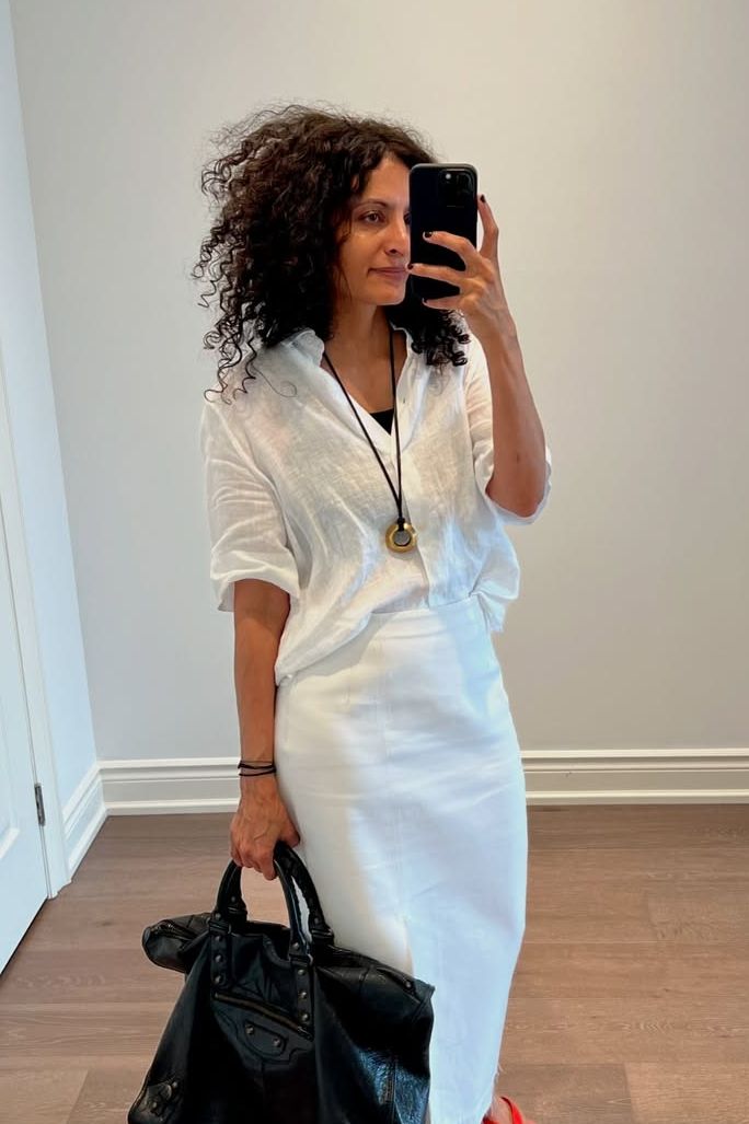 Influencer wearing a linen shirt with a white skirt