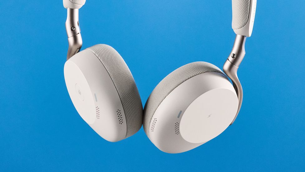 Jabras Evolve3 75 conferencing headset in hand against a blue background