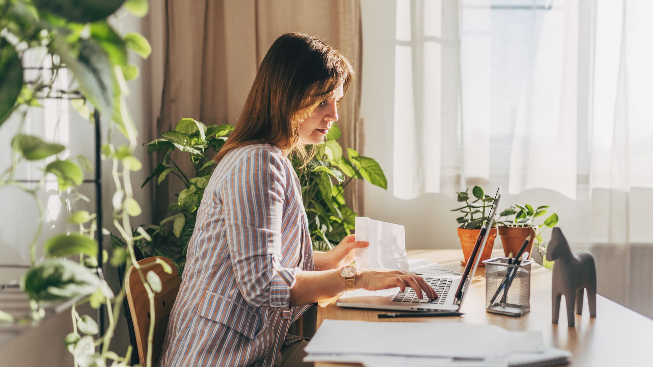 a woman sitting at her home office reviewing document