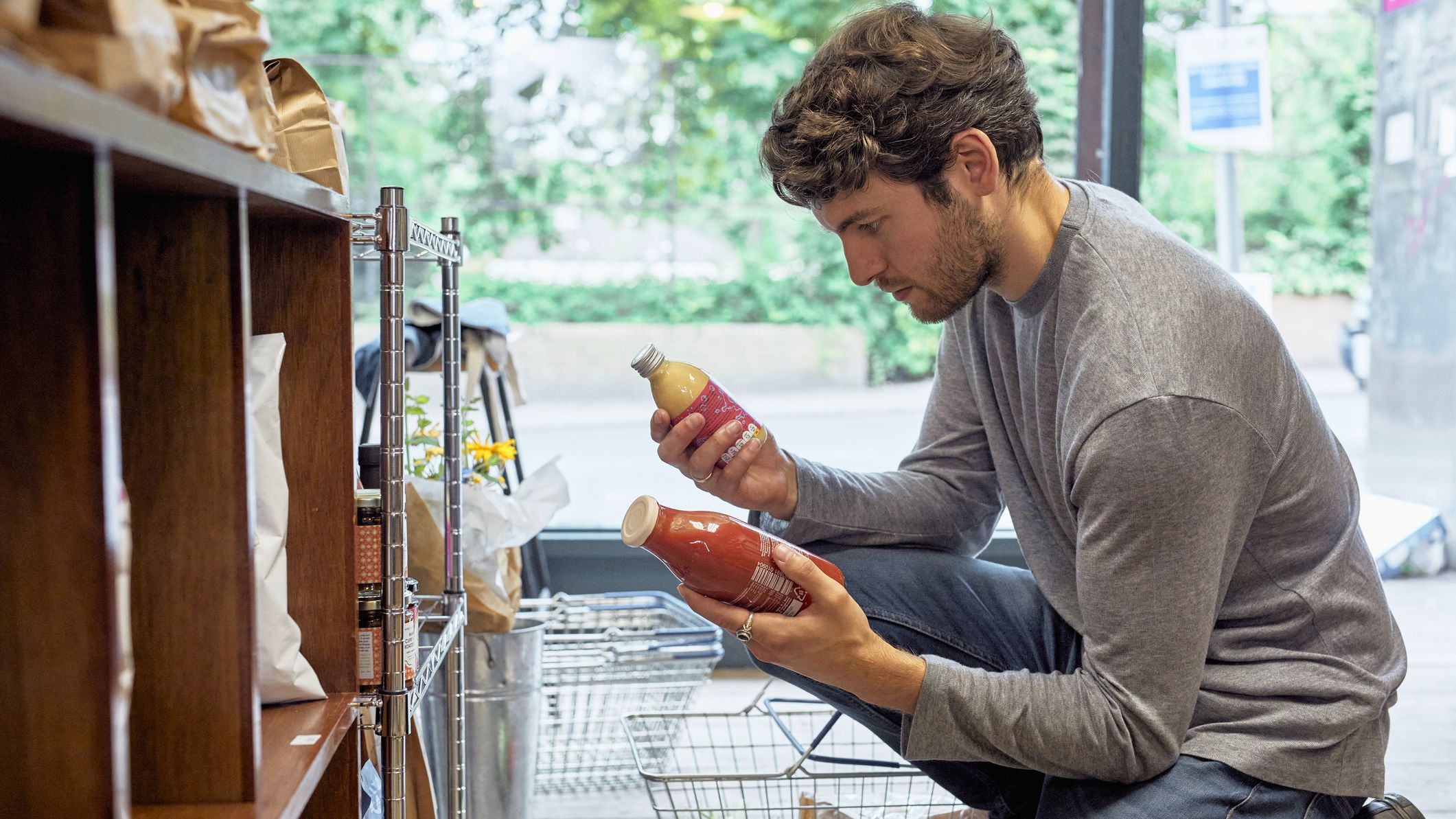a man compares two juice bottles
