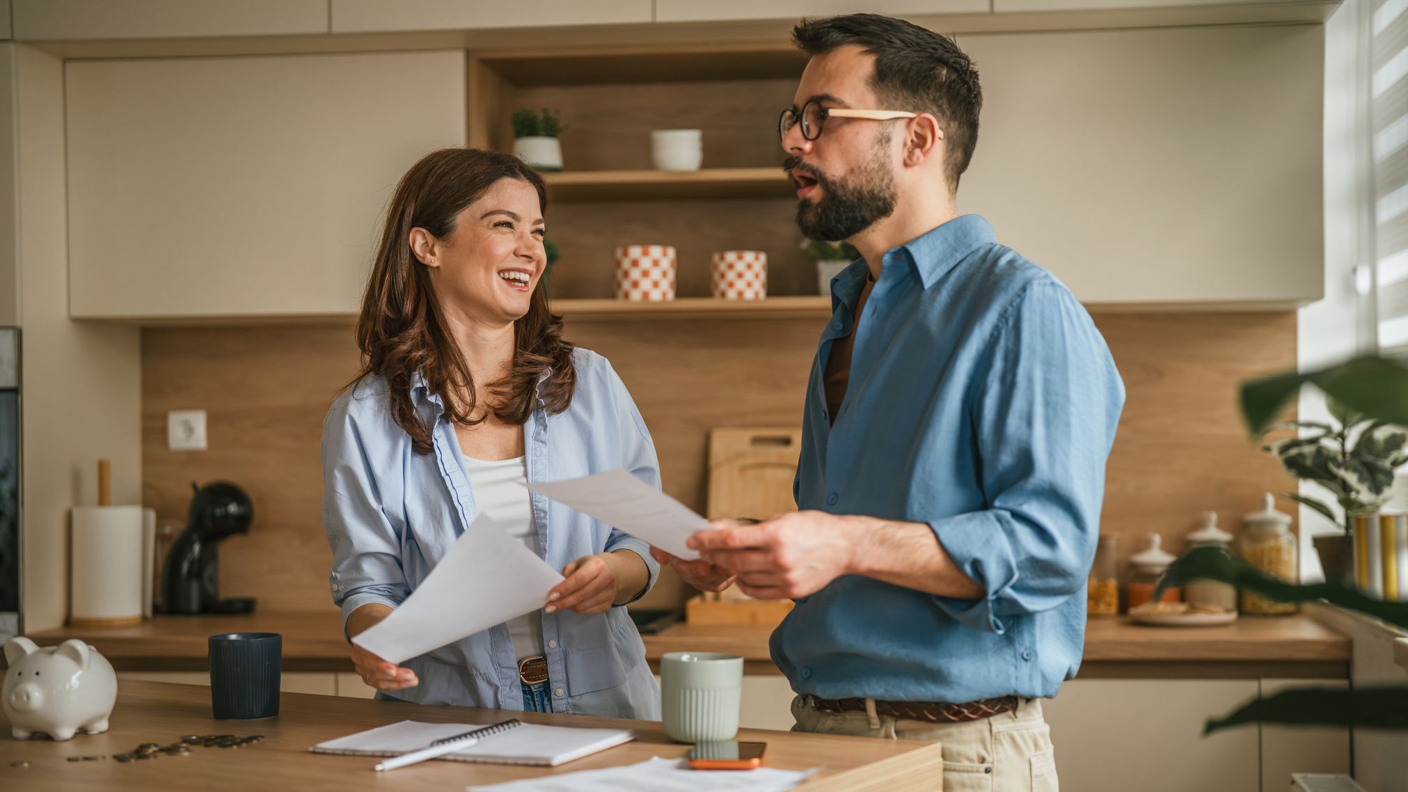 Happy couple managing home finances and planning budget