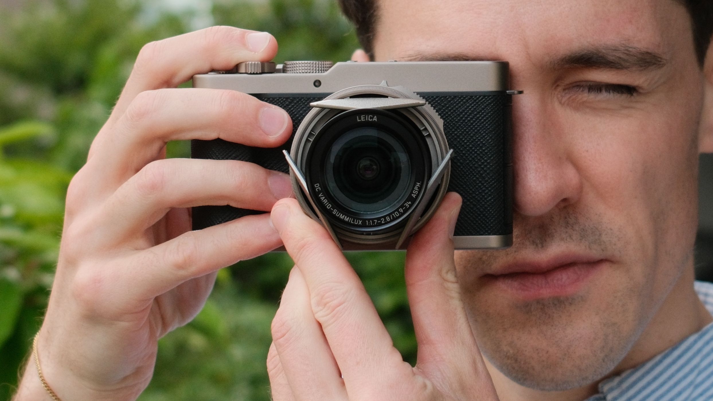 Rear view of the Panasonic Lumix L10 compact camera held in one hand.