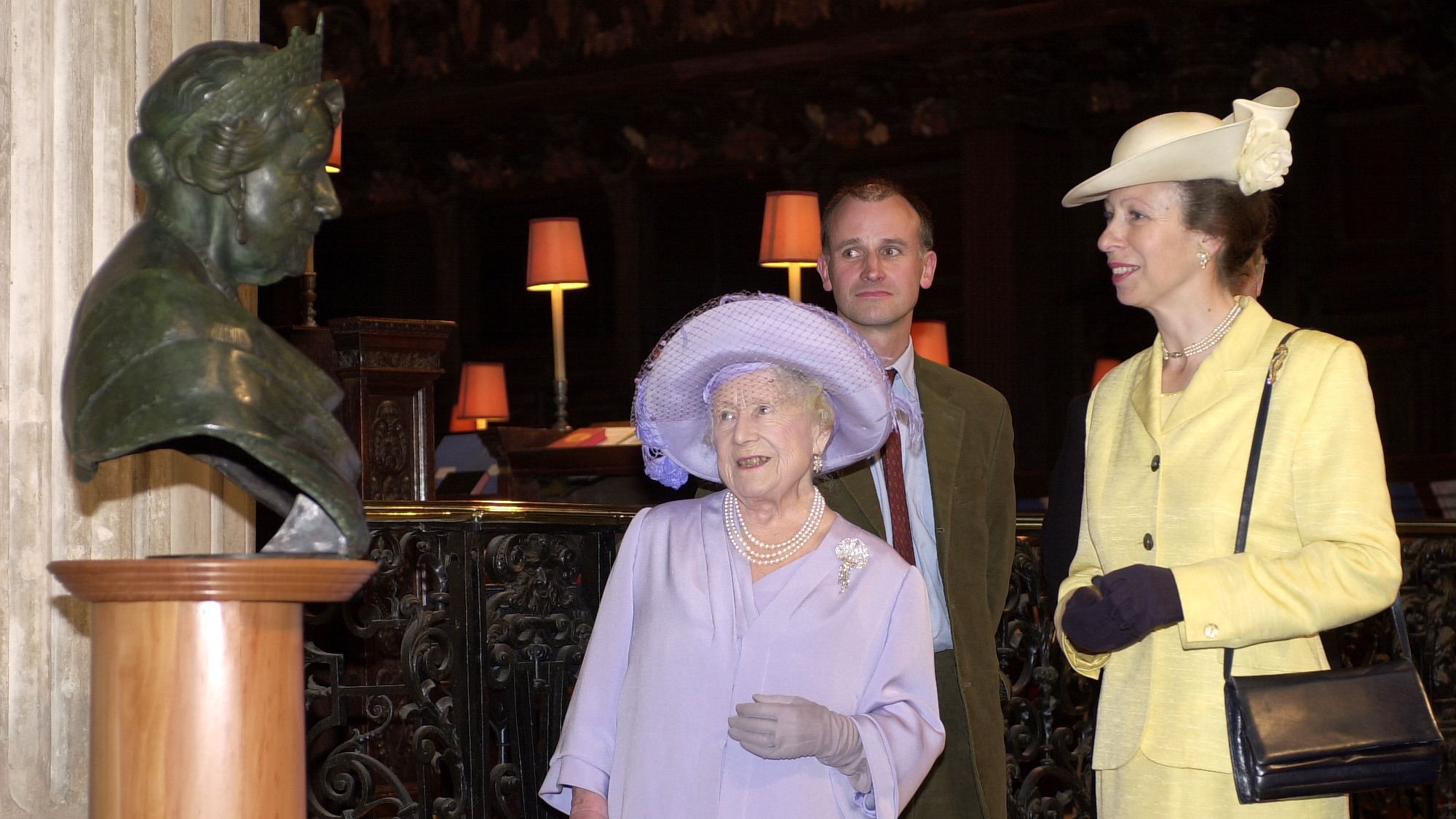 The Queen Mother and Princess Anne look at a new bust of the Queen Mother created by Martin Jennings (pictured behind the Queen Mother)