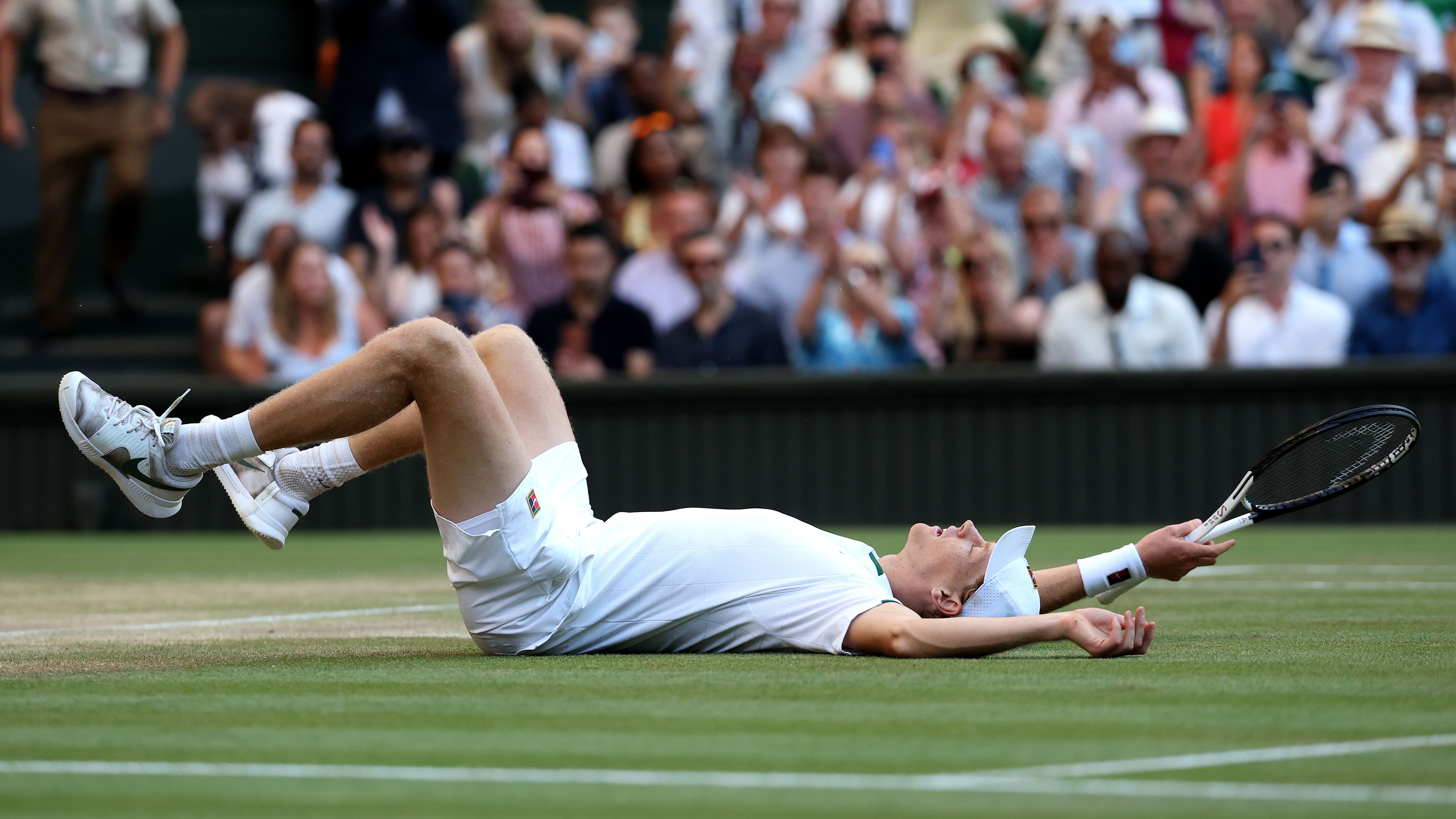 Jannik Sinner falls to the ground after beating Alexander Zverev in the Wimbledon 2026 Men's Singles final
