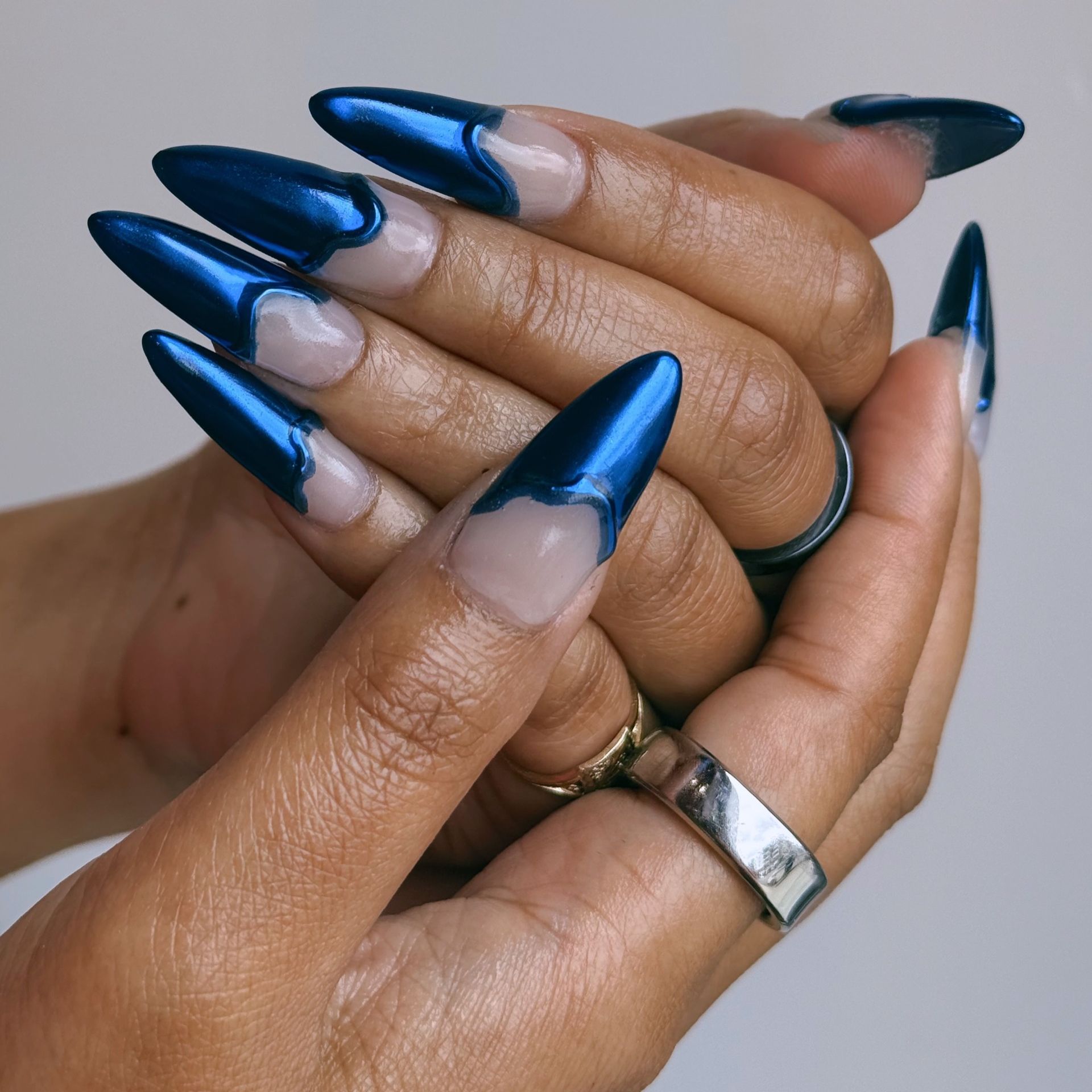 blue manicure dripping chrome with a silver ring