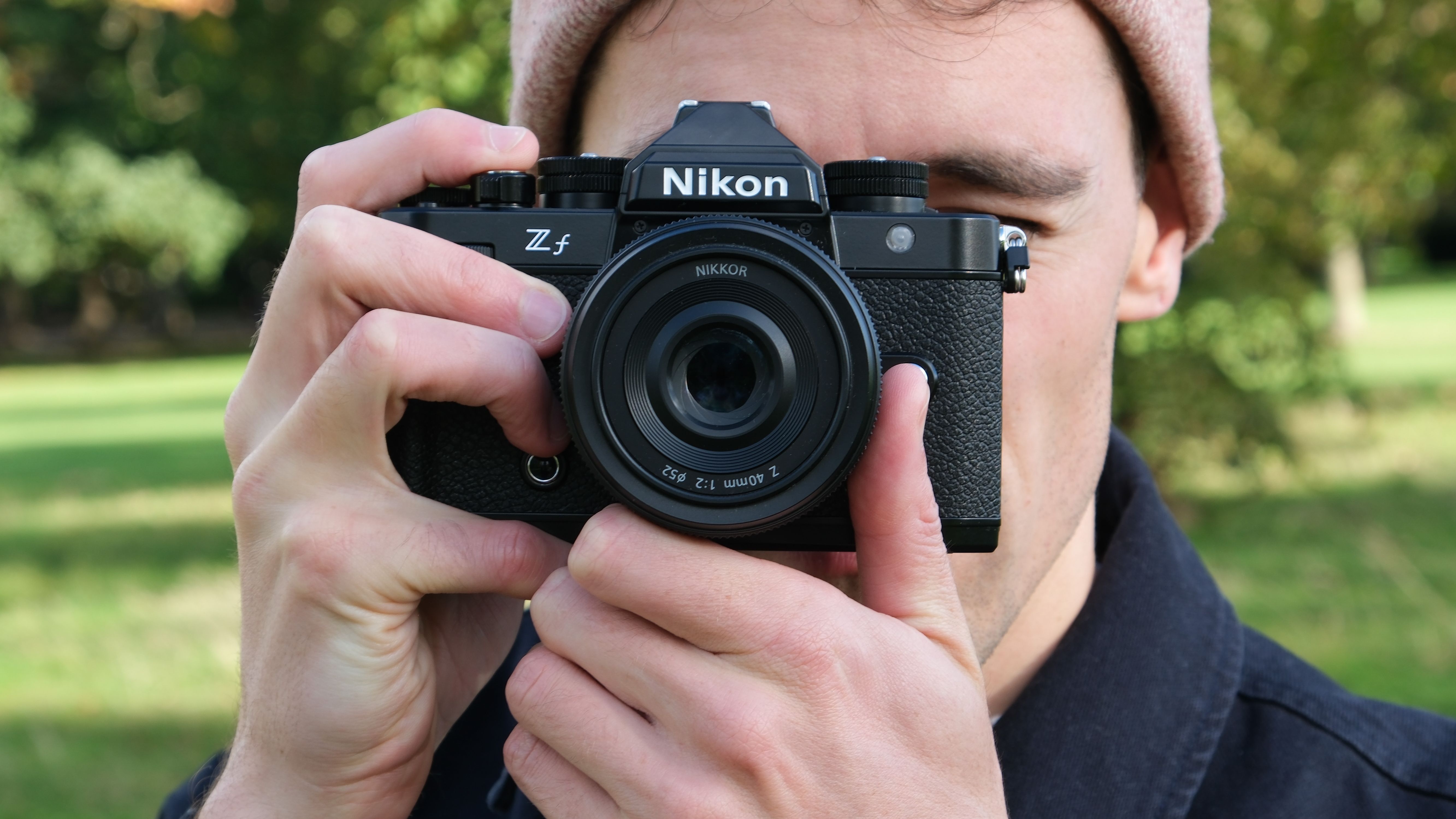 Nikon Zf camera held up to a face