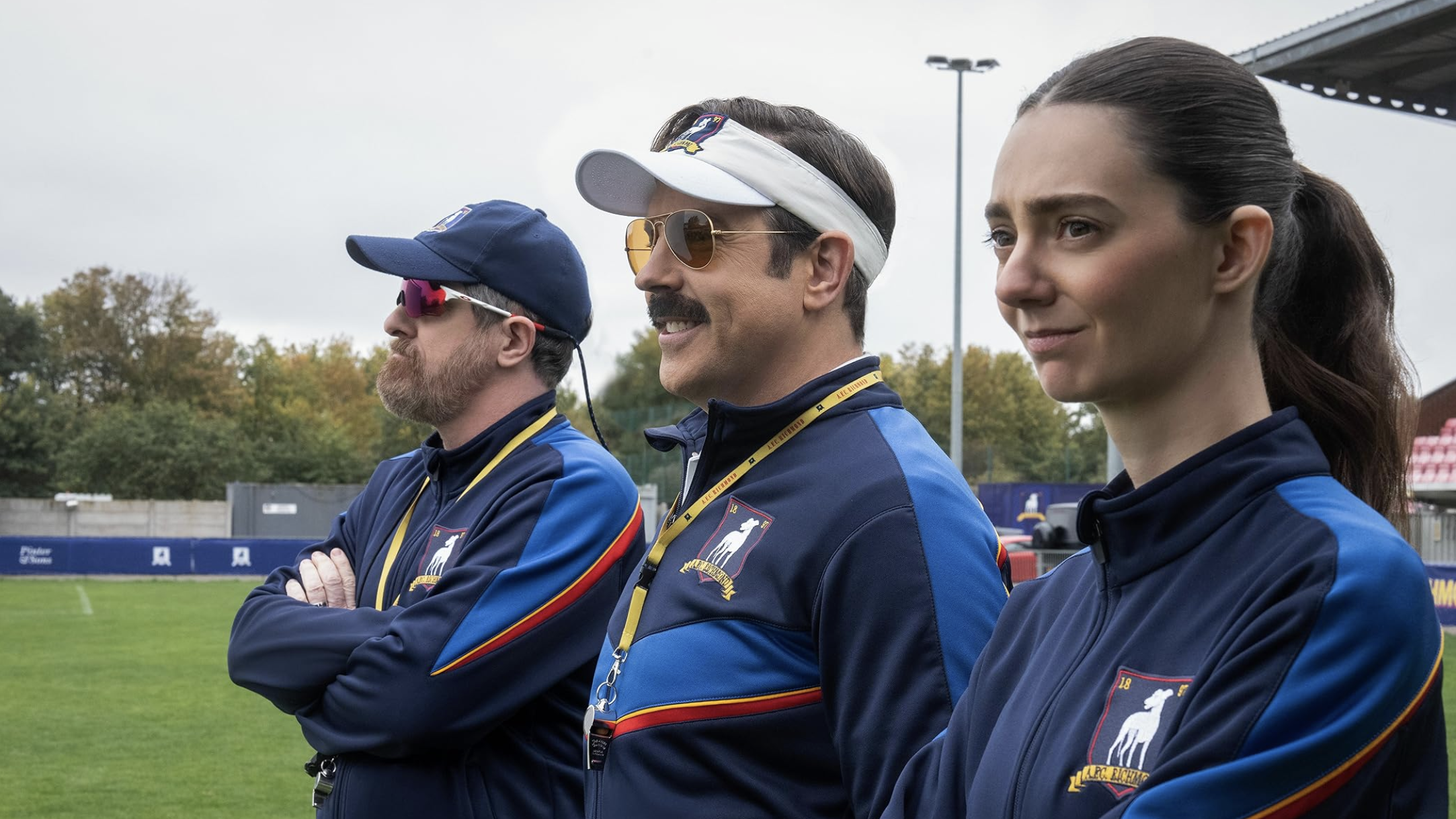 a production image from Ted Lasso showing the three coaches for the women's team