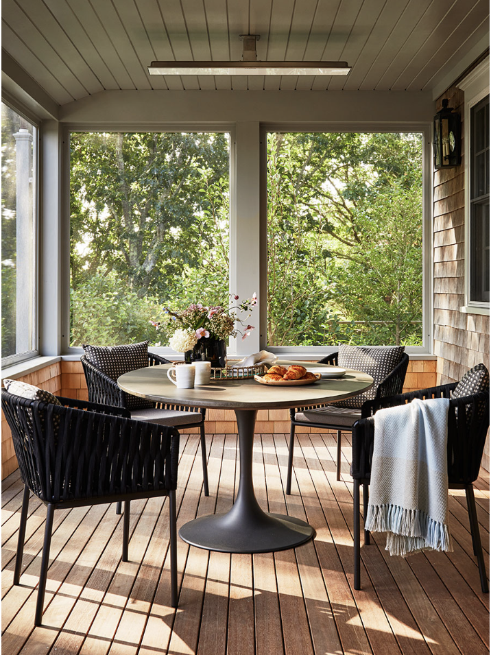outdoor dining set on a covered porch