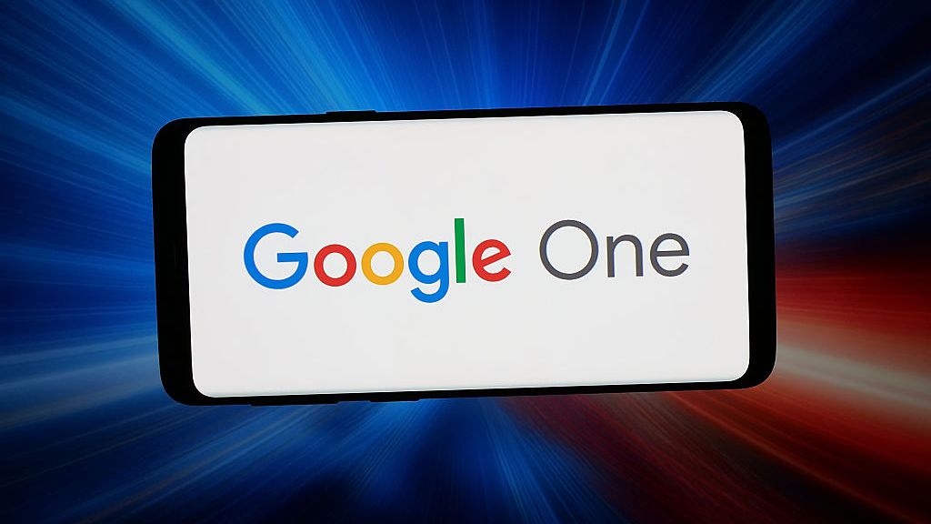 In this photo illustration, the cloud subscription service Google One logo is seen displayed on a smartphone in front of abstract background