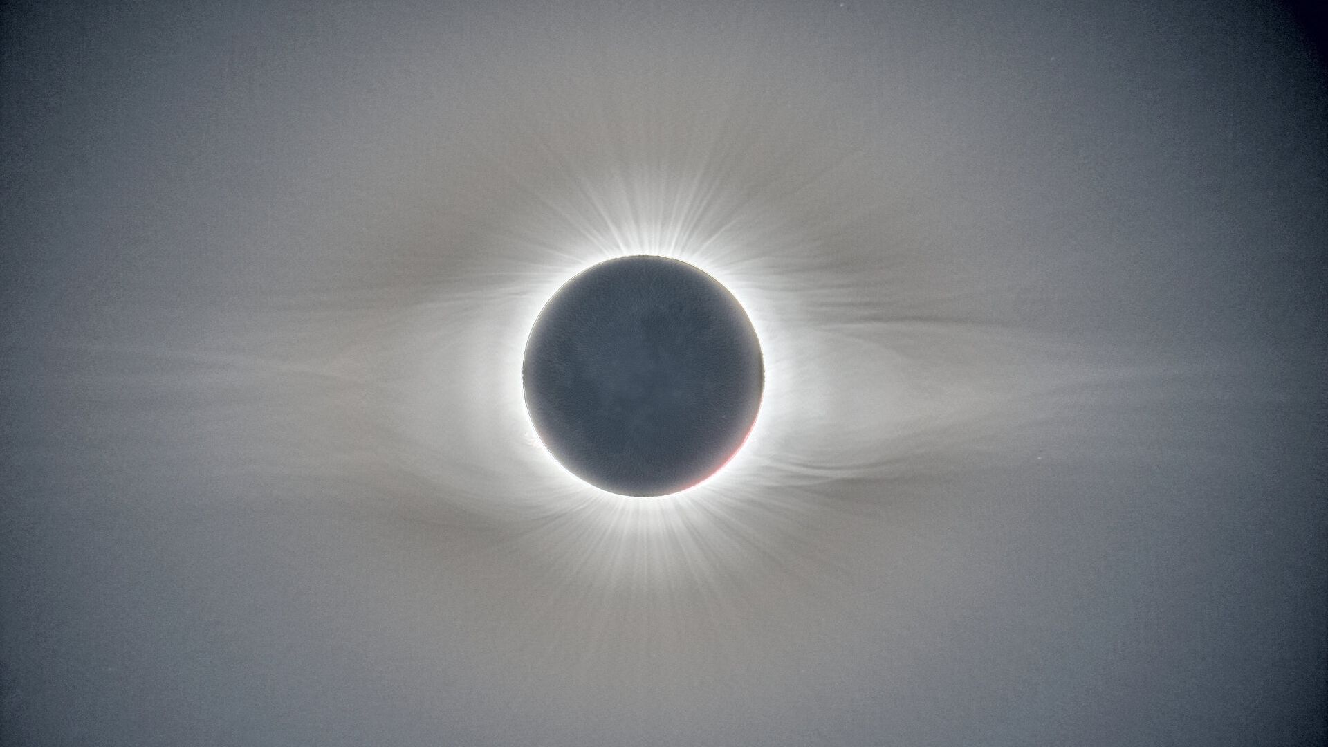 white halo surrounds the sun, it looks like it is streaming out into the depths of space.