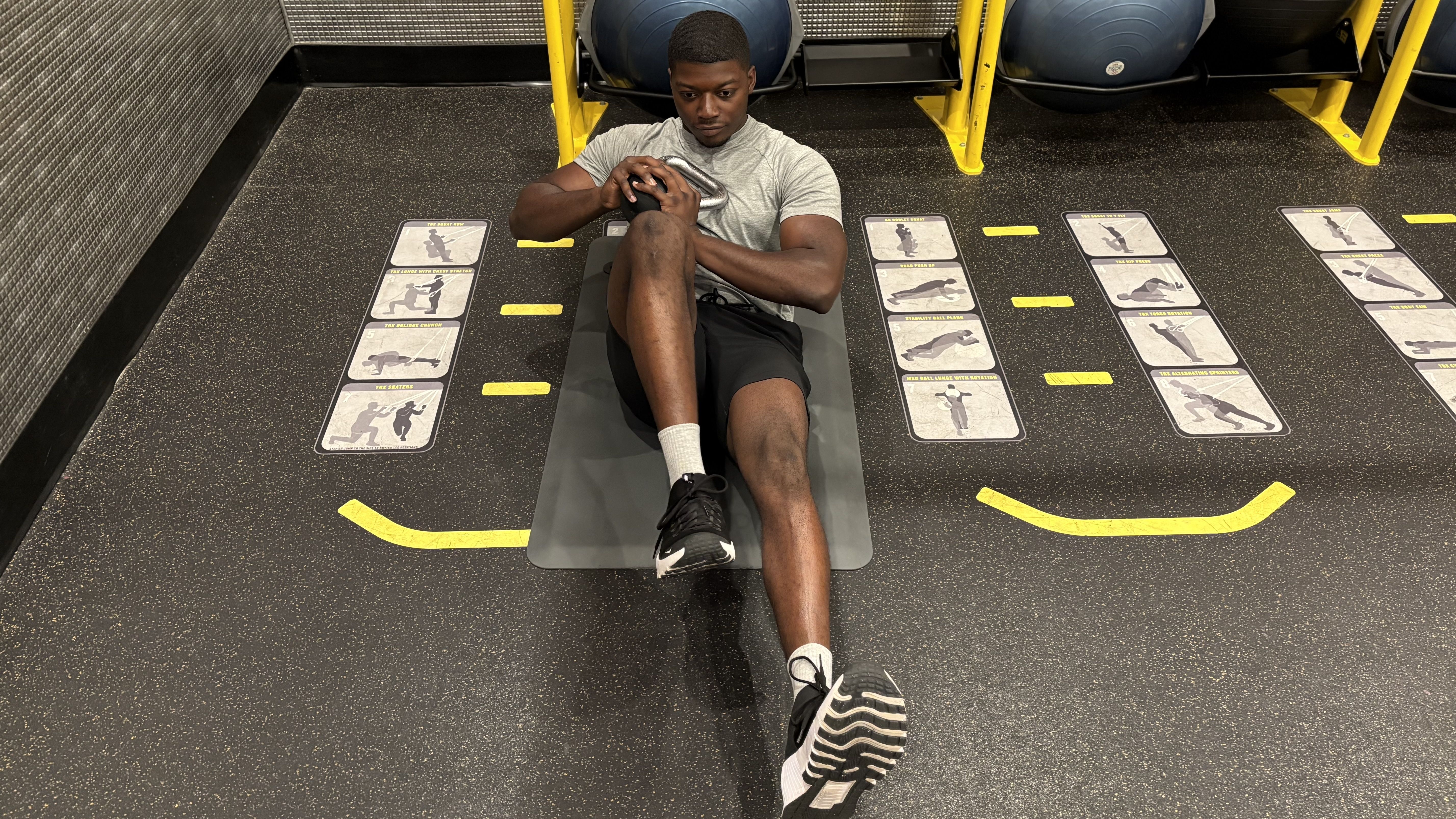 Man exercises with kettlebell in gym