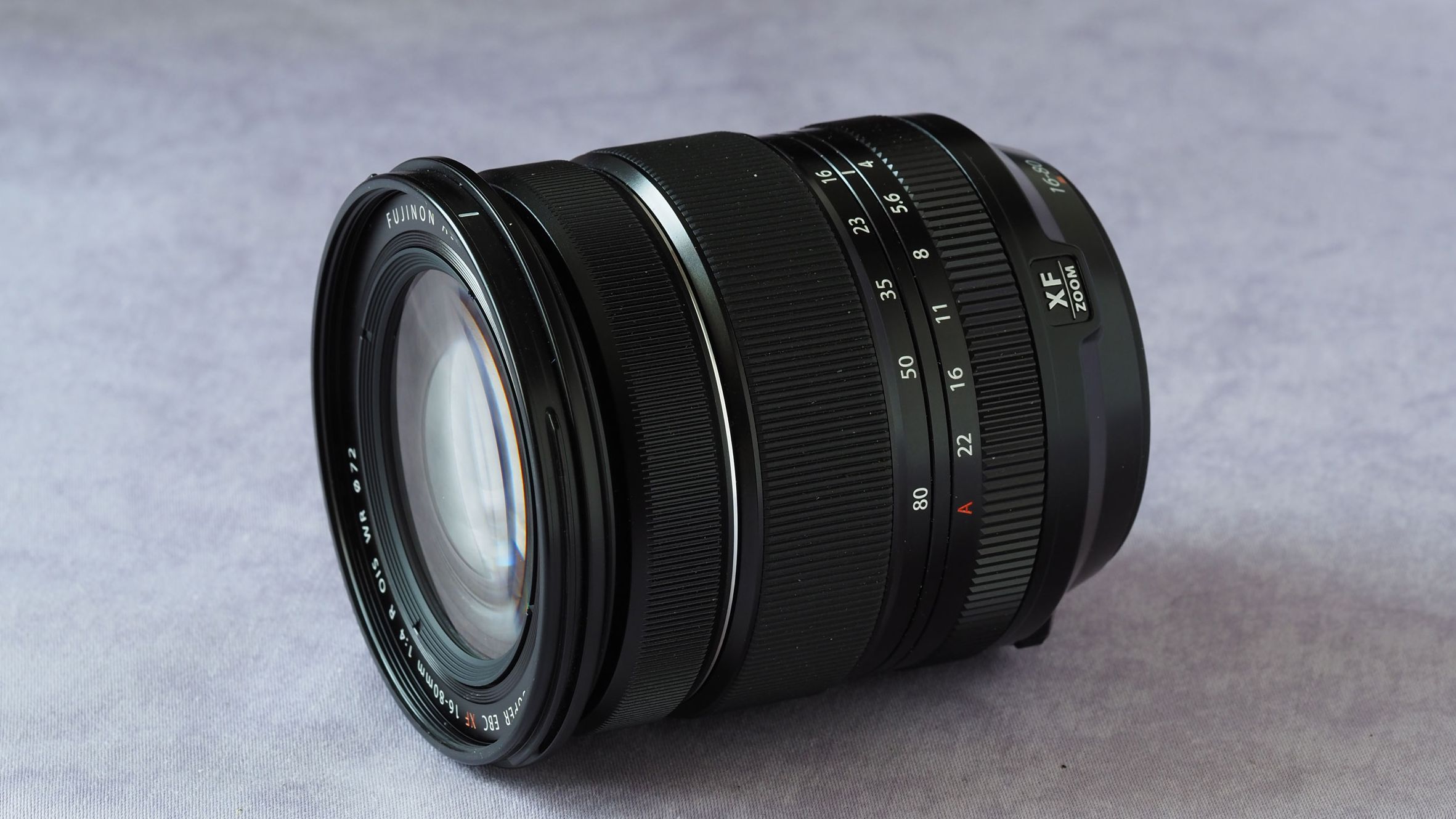 Fujinon XF 16-80mm f/4 R OIS WR camera lens on a marbled surface