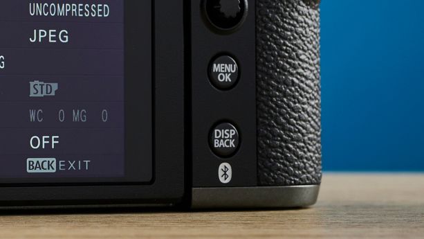 A Fujifilm X-T50 camera in the charcoal grey colorway