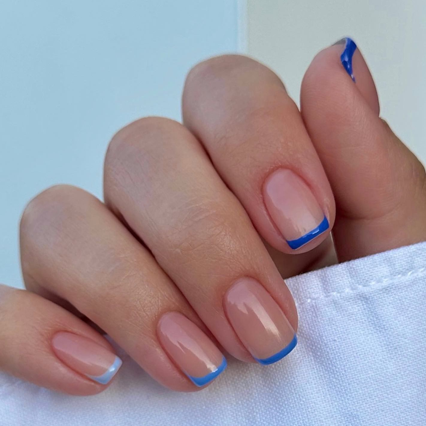 blue manicure with shades of blue french tips