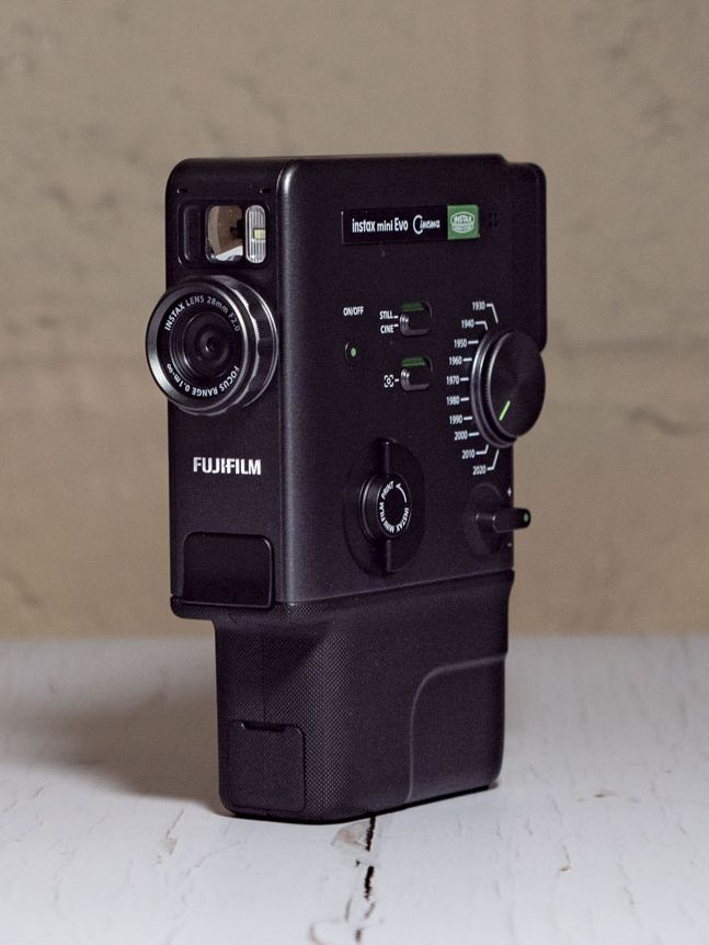 Fujifilm Instax Mini Evo Cinema on a white wooden surface