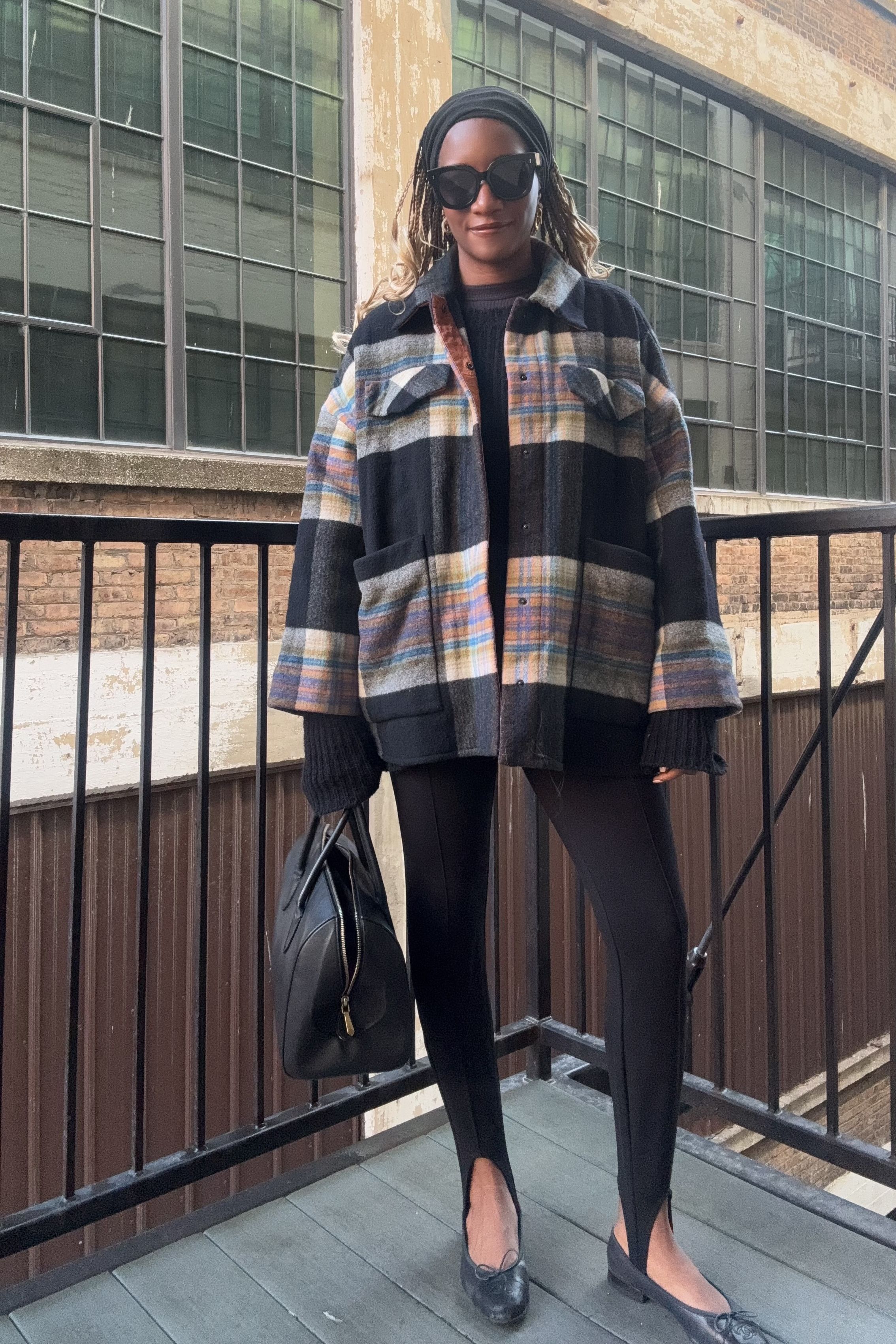 Danielle Prescod styles a colorful checkeed coat with stirrup leggings and ballet flats