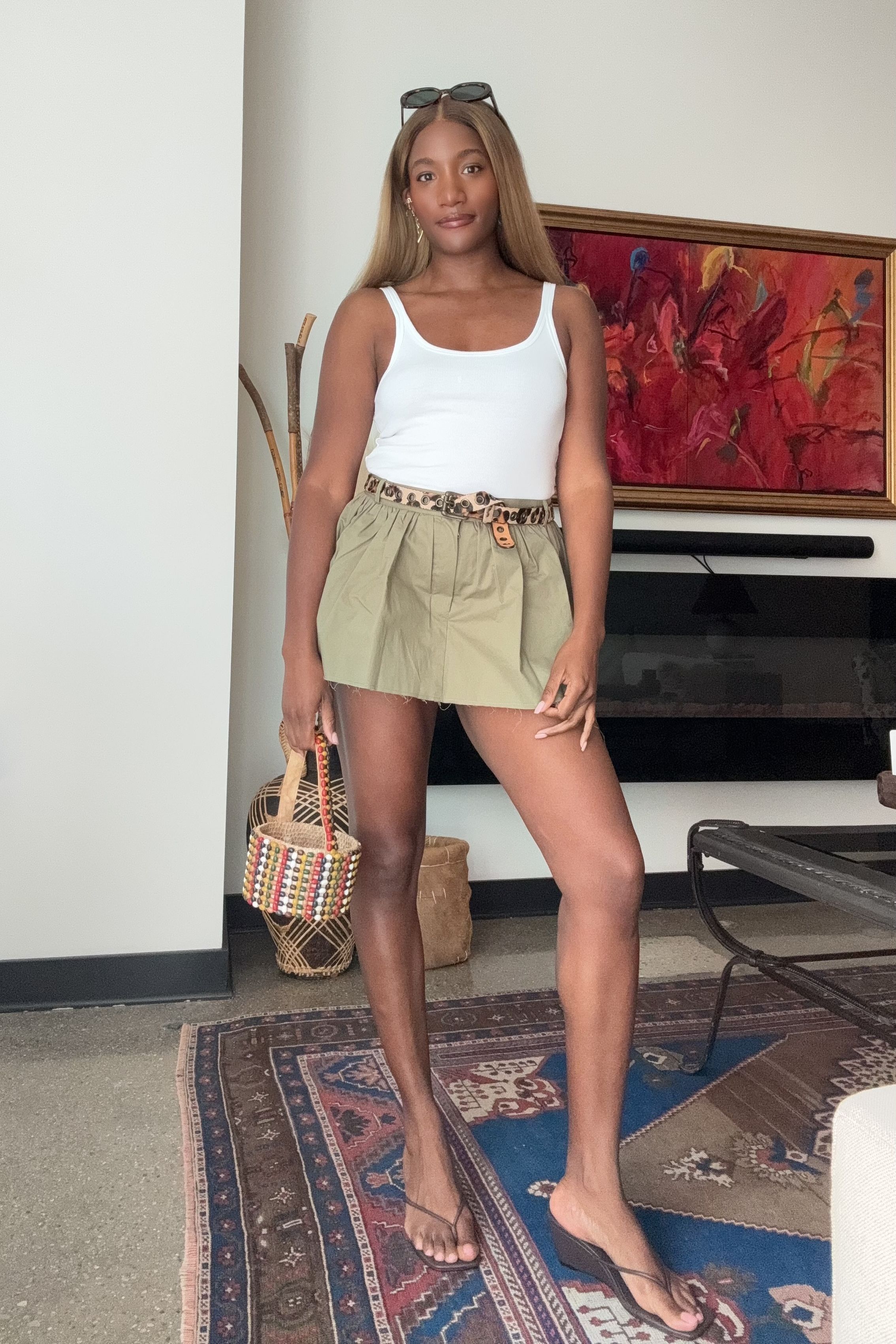 Danielle Prescod wears wedge flip-flops with a micro skort