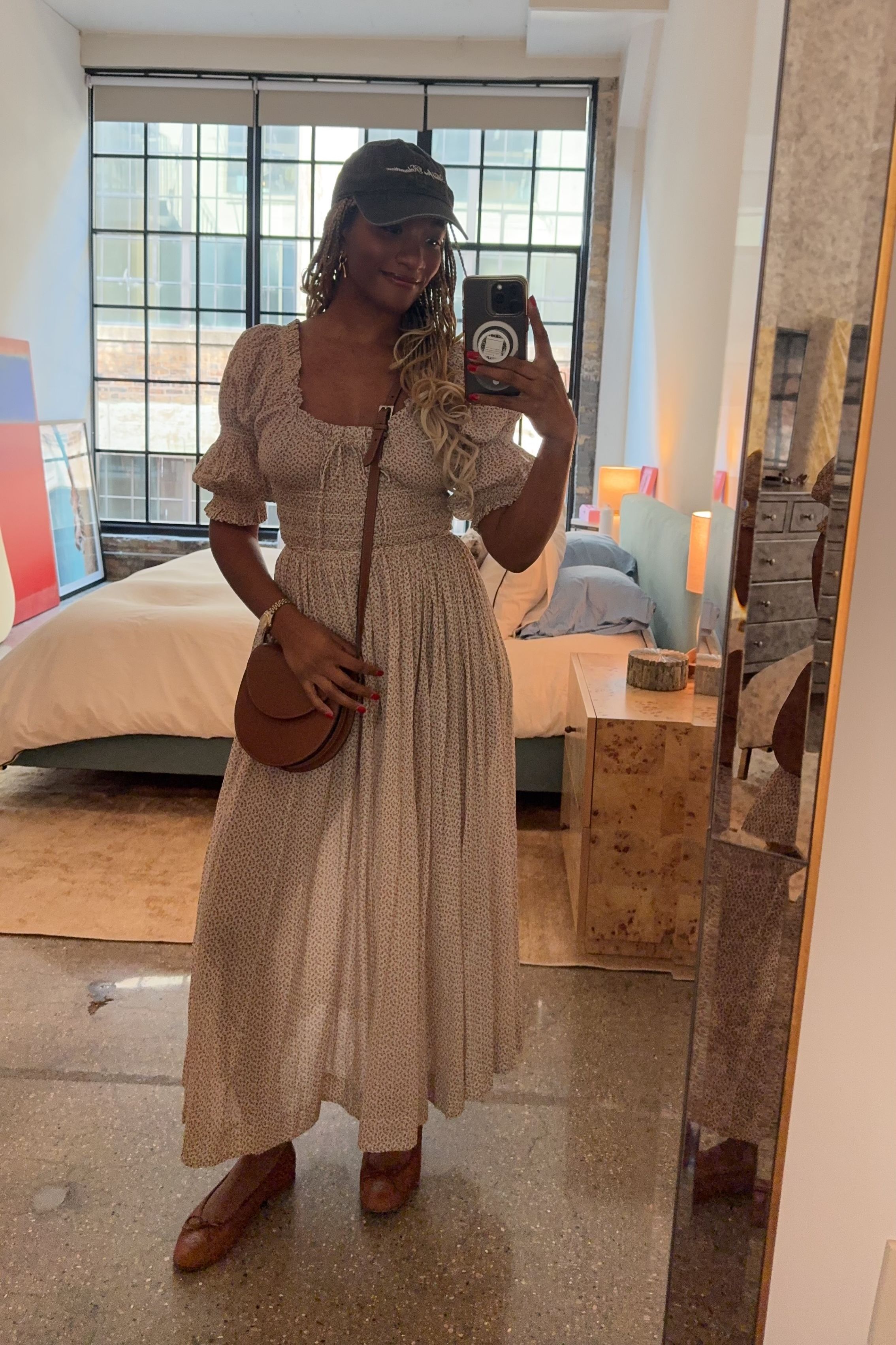 Danielle Prescod styles a floaty dress with a ball cap and ballet flats